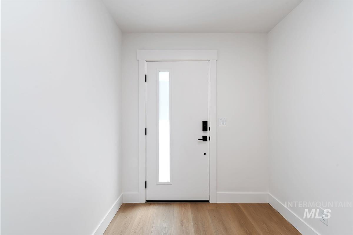 Foyer with baseboards and light wood finished floors