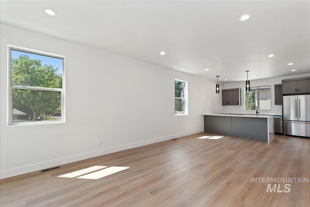 Unfurnished living room featuring recessed lighting and light wood-type flooring