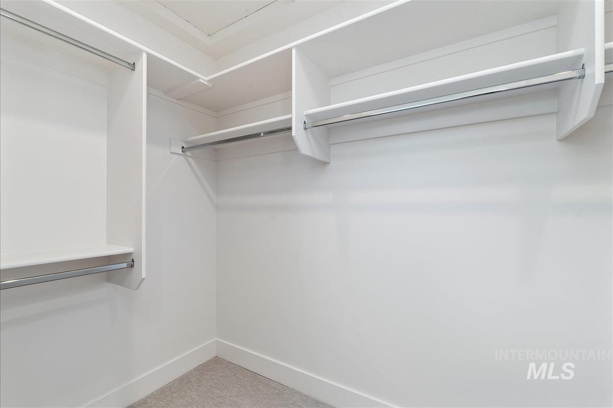 Spacious closet with light carpet