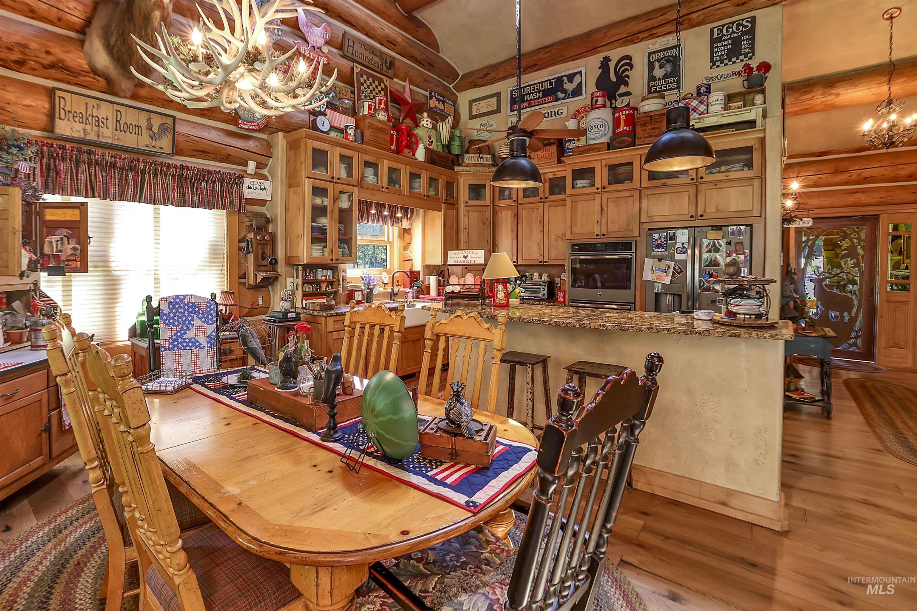 Dining area featuring a chandelier, rustic walls, and light wood-type flooring
