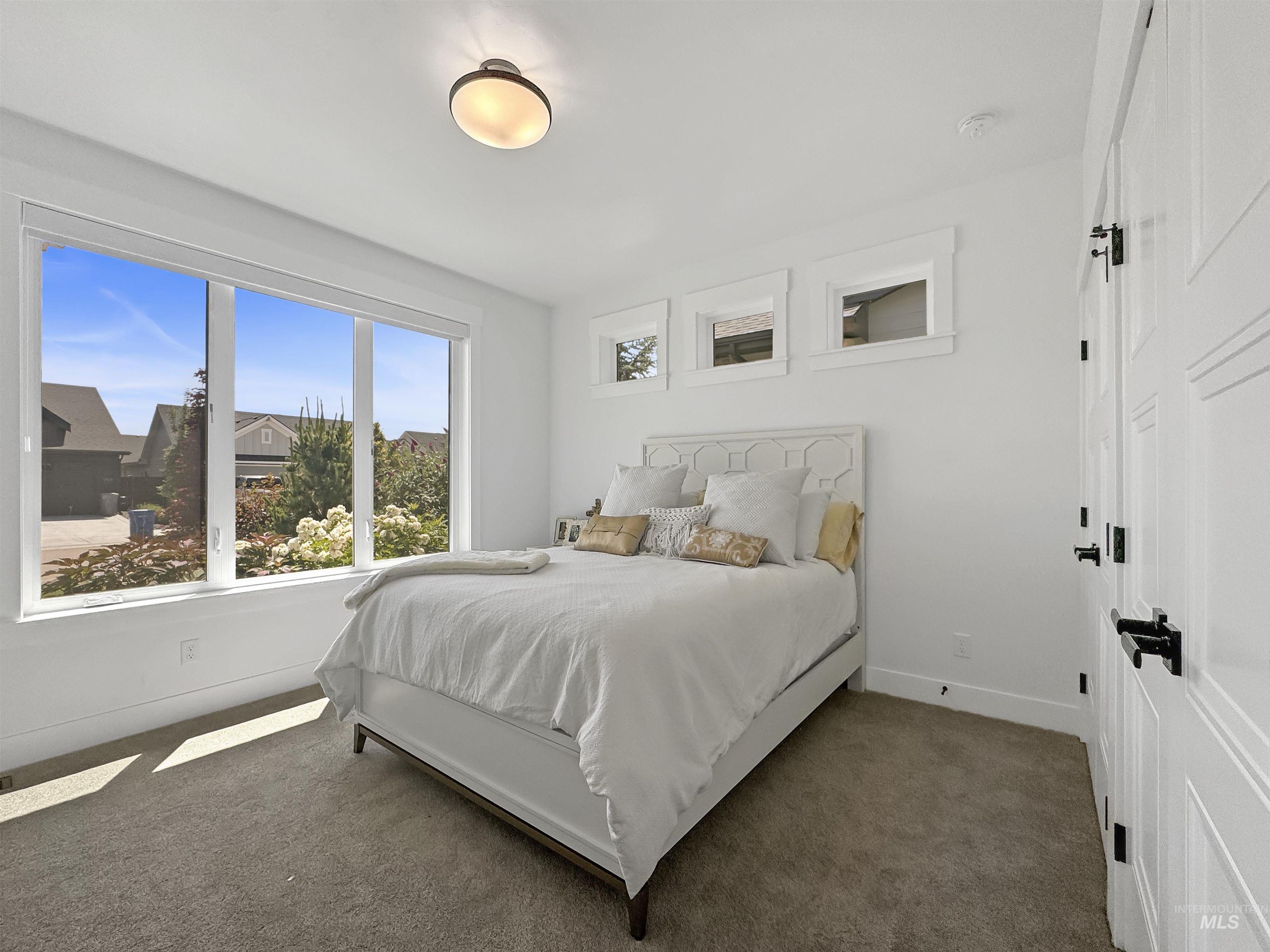 Carpeted bedroom featuring baseboards