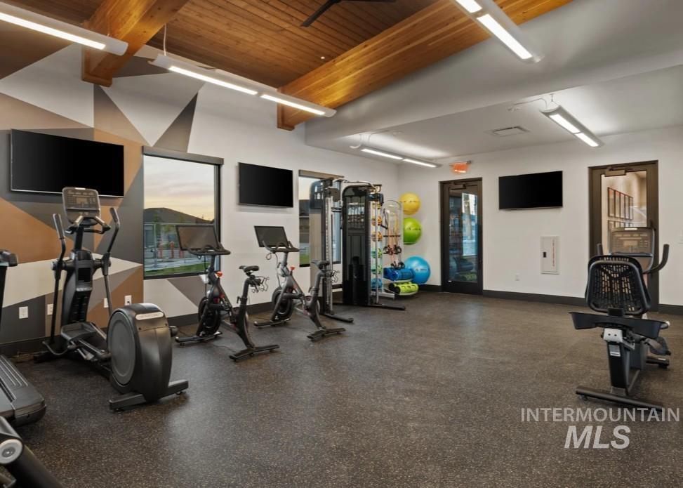 Exercise room with a wood ceiling with exposed beams