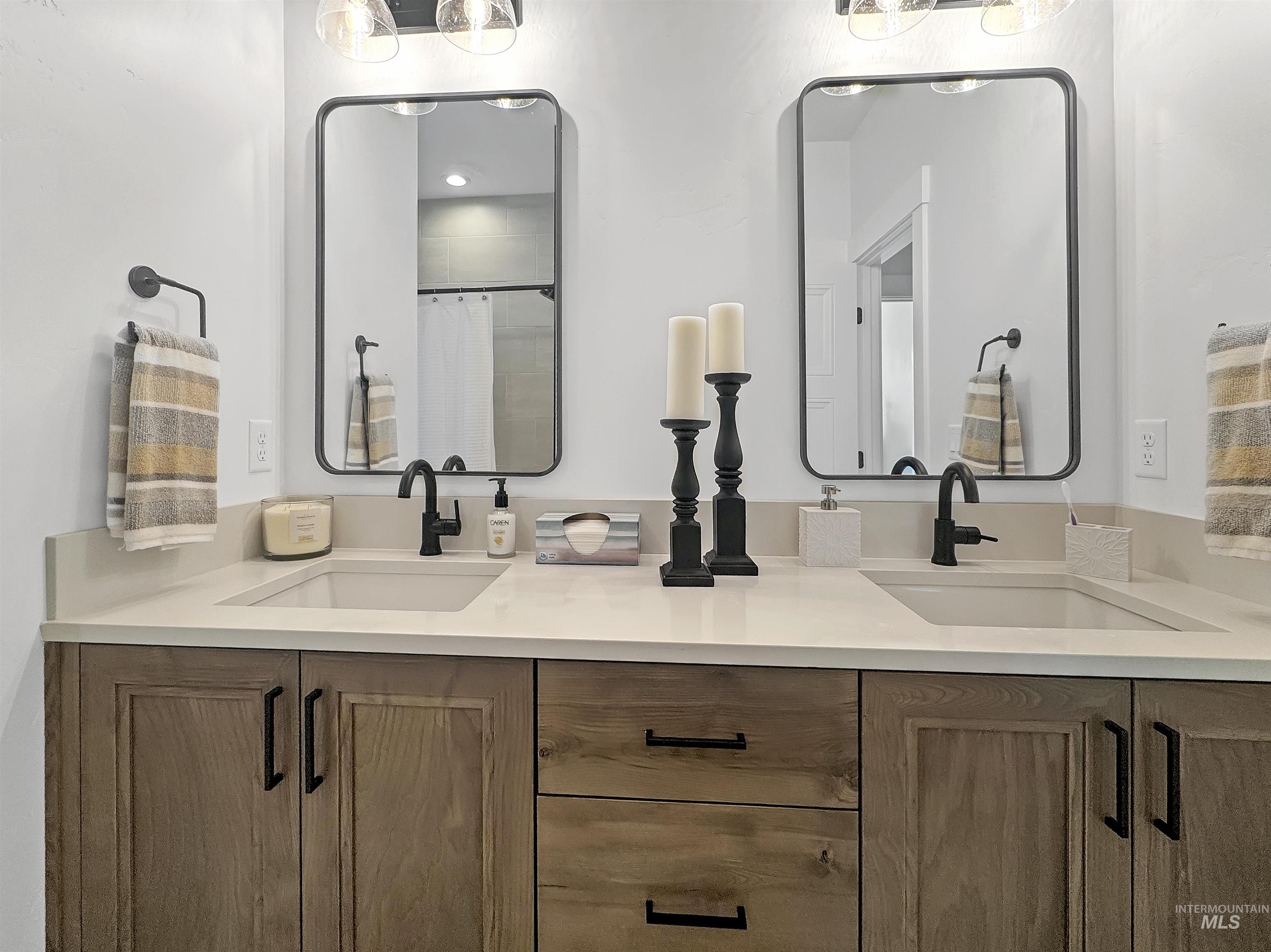 Bathroom featuring double vanity and a shower with shower curtain