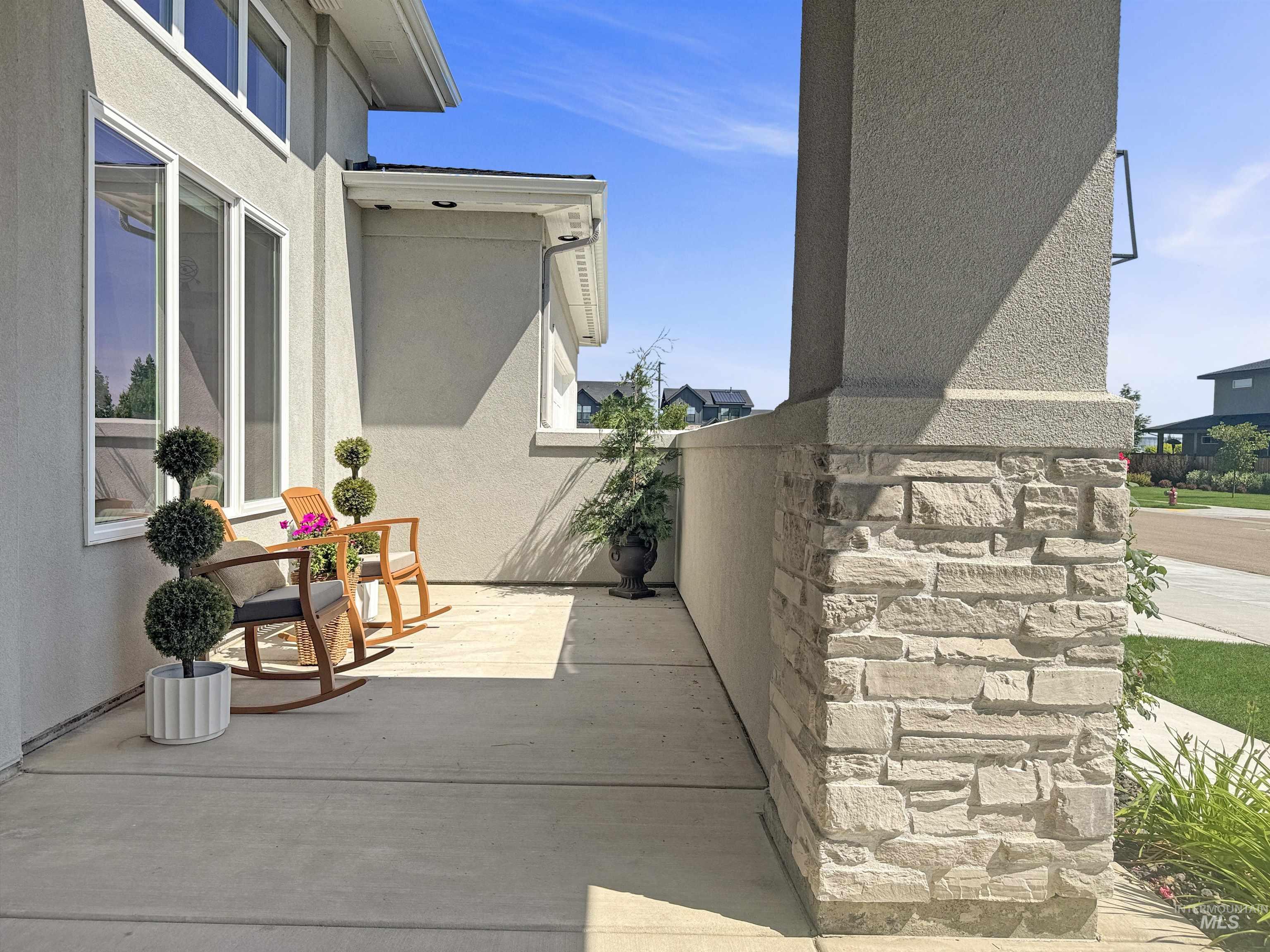 View of property exterior featuring stucco siding and stone siding