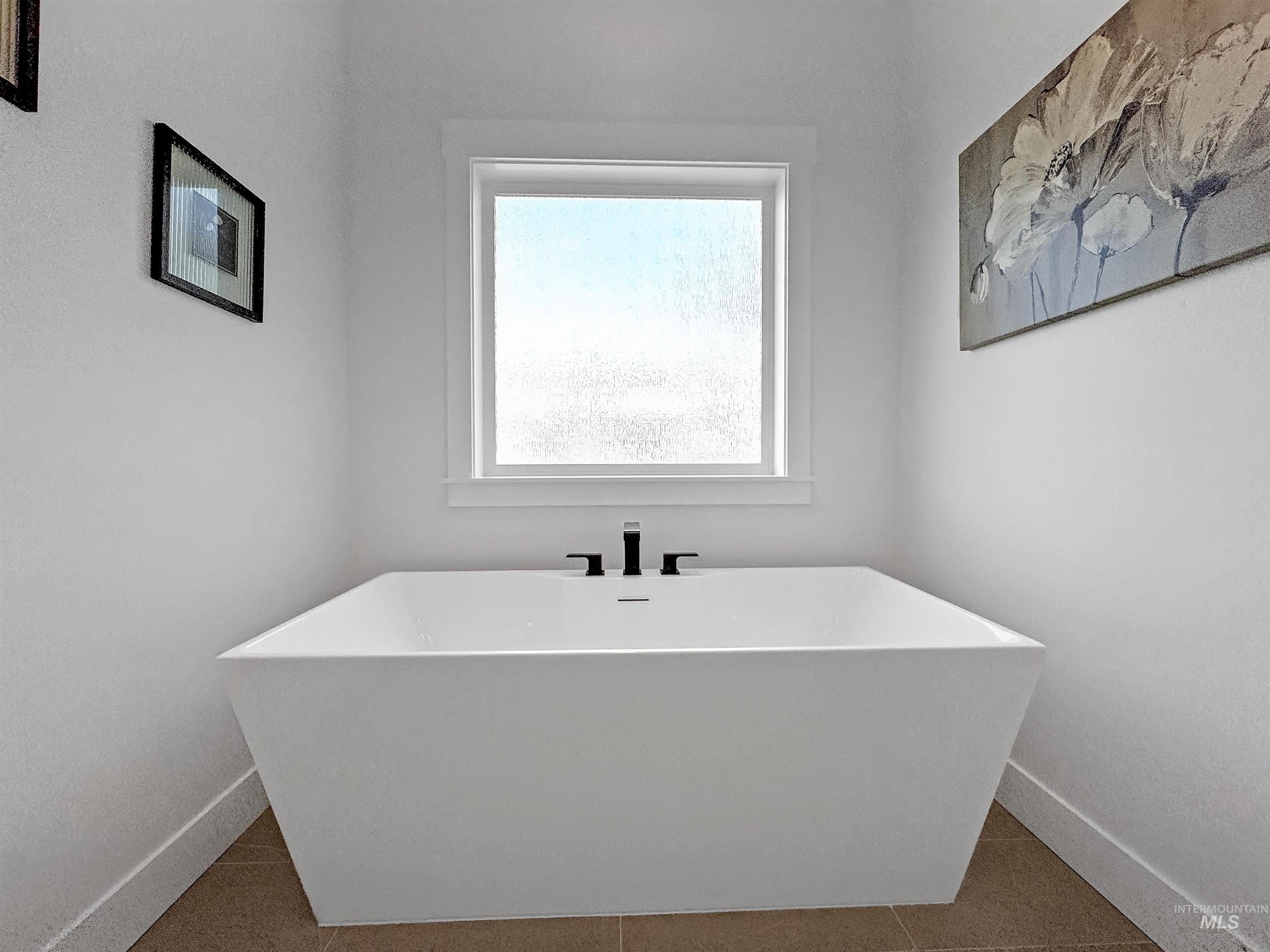 Bathroom featuring tile patterned floors and a soaking tub