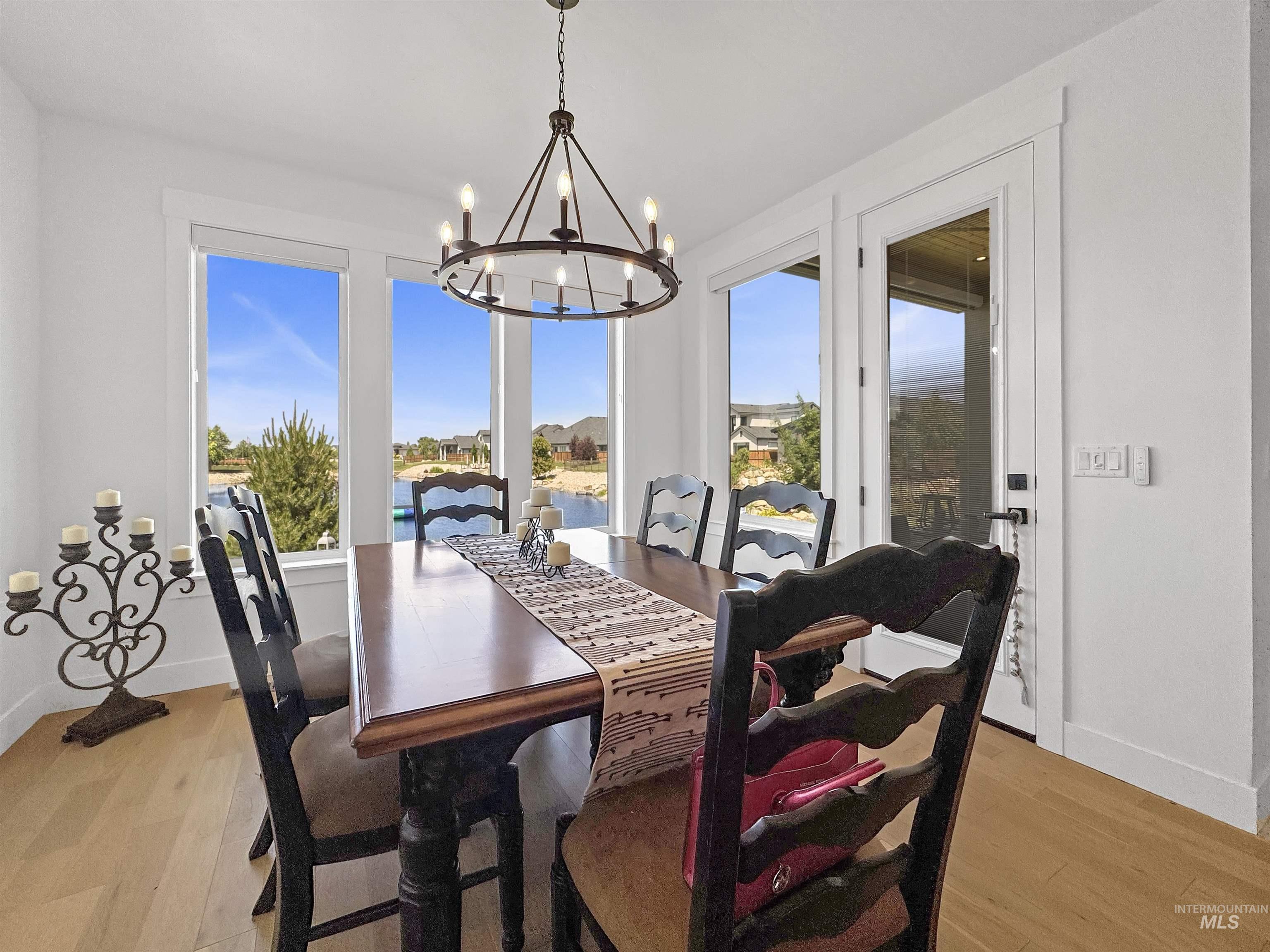 Dining room featuring light wood finished floors and a chandelier