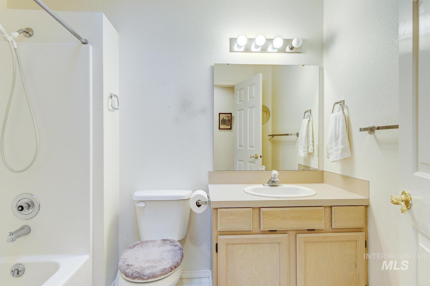 Bathroom with shower / washtub combination and vanity