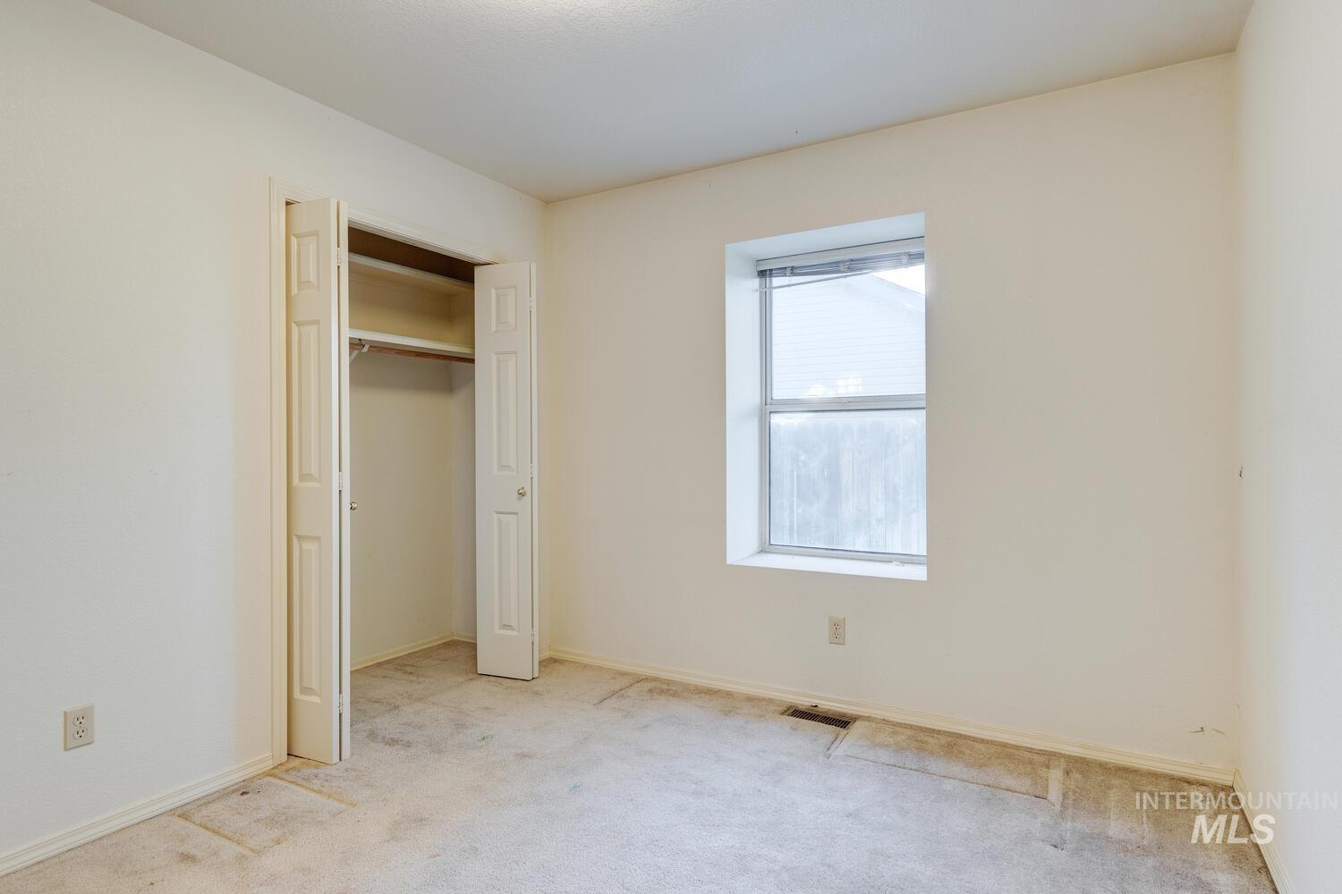 Unfurnished bedroom with carpet and a closet
