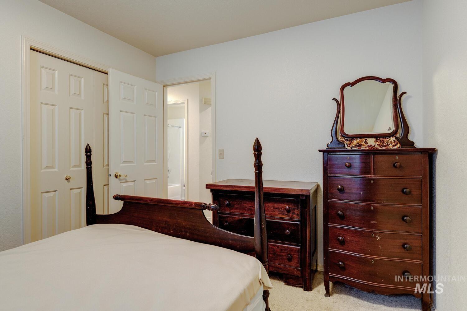 Carpeted bedroom featuring a closet