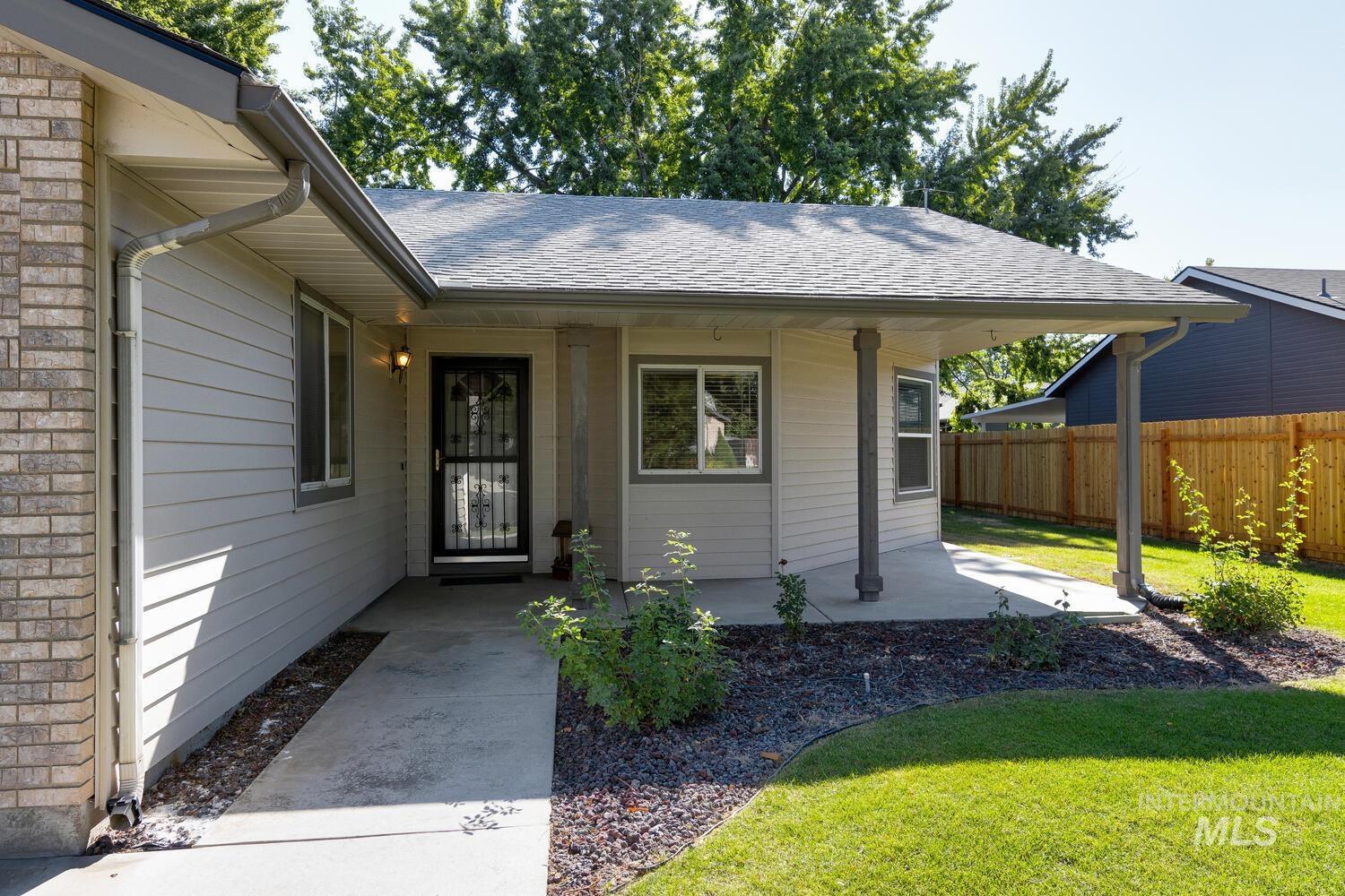 Doorway to property featuring roof with shingles
