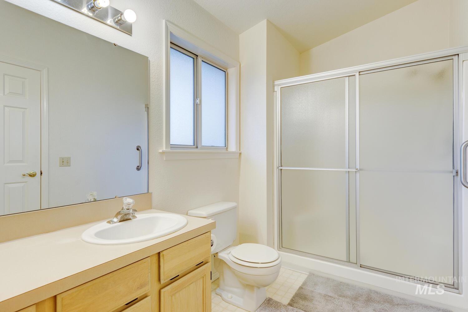 Bathroom with vanity and a stall shower