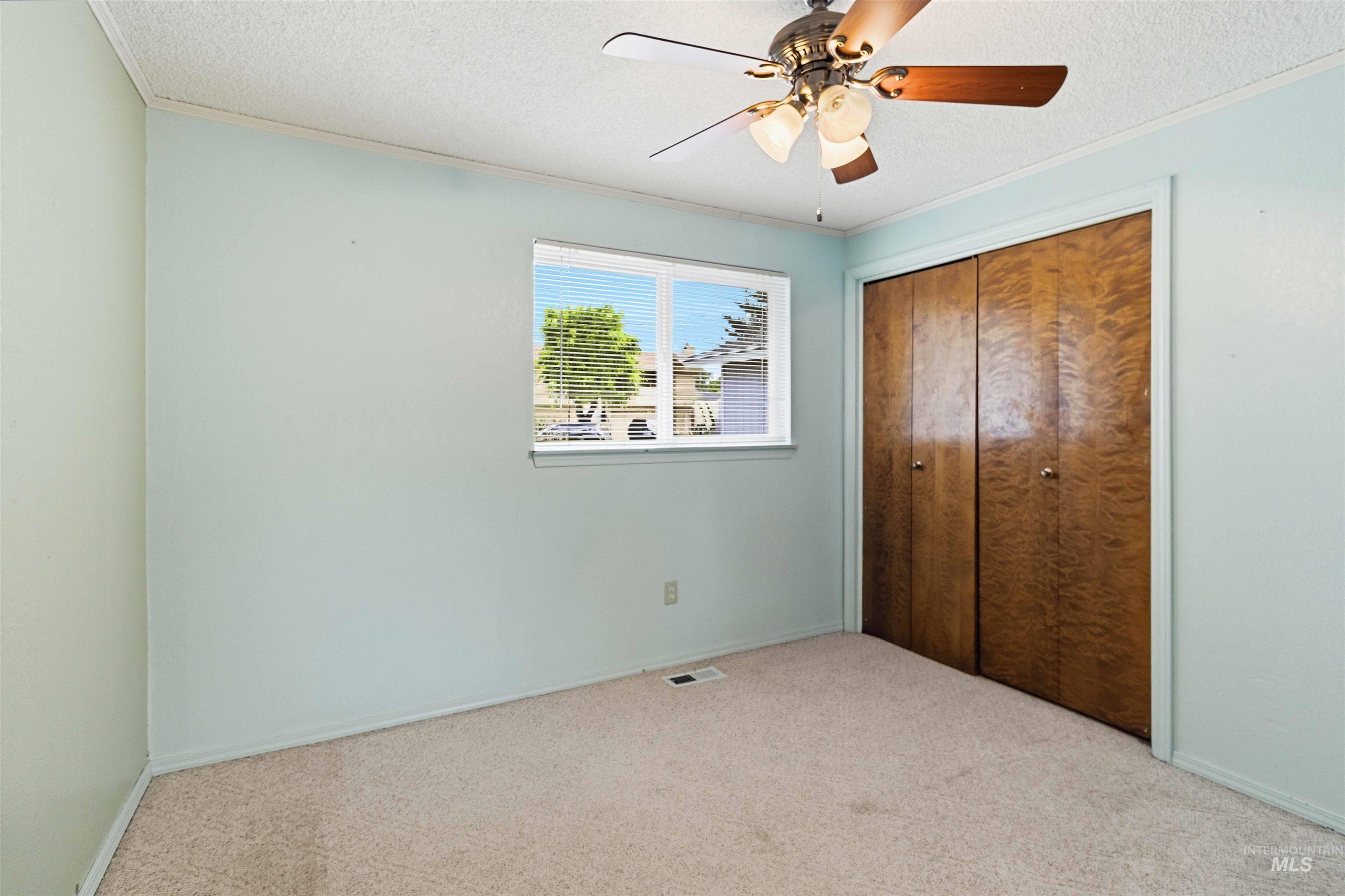 Carpeted interior room with light blue walls