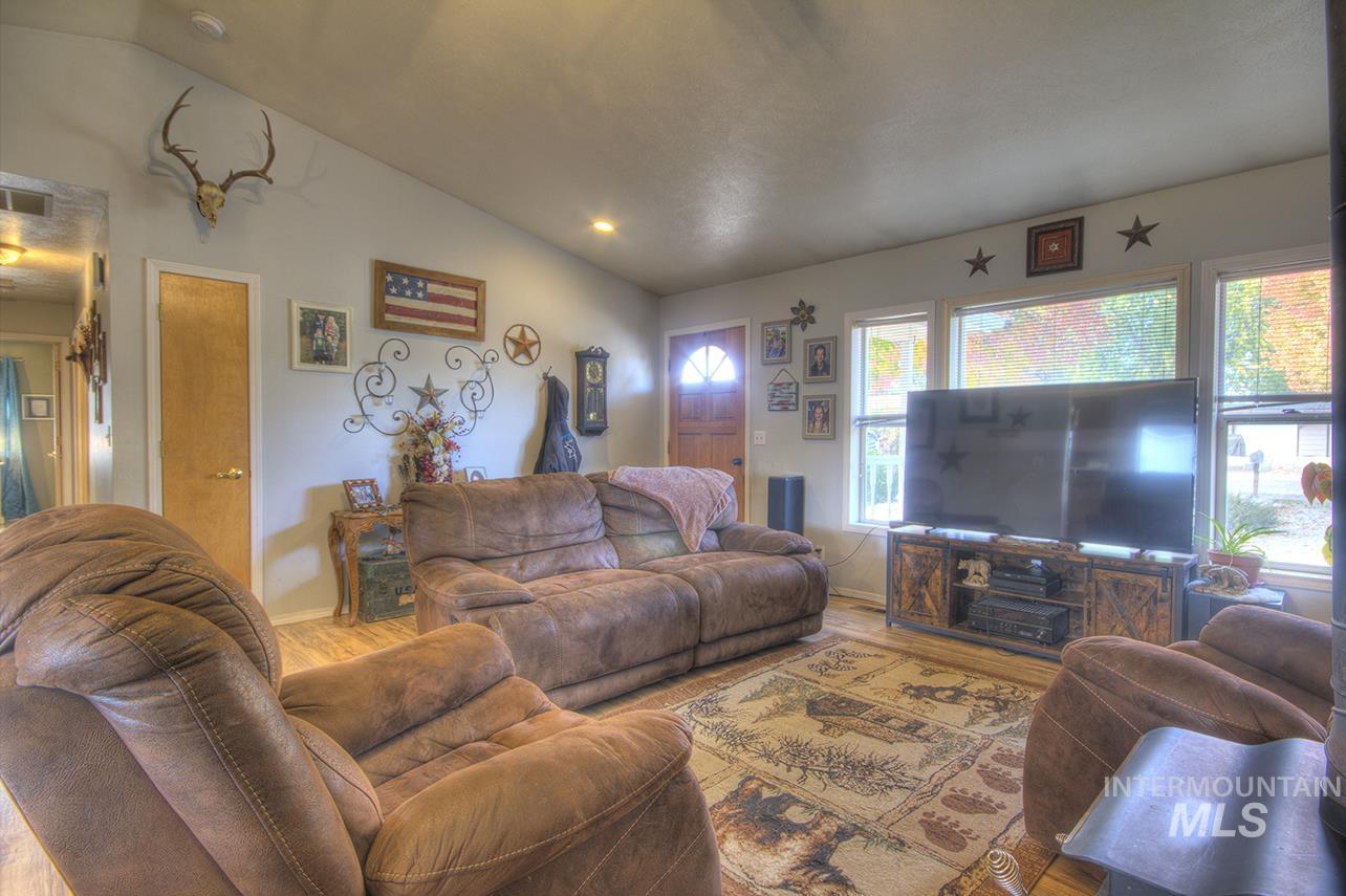 Living room featuring vaulted ceiling and wood finished floors