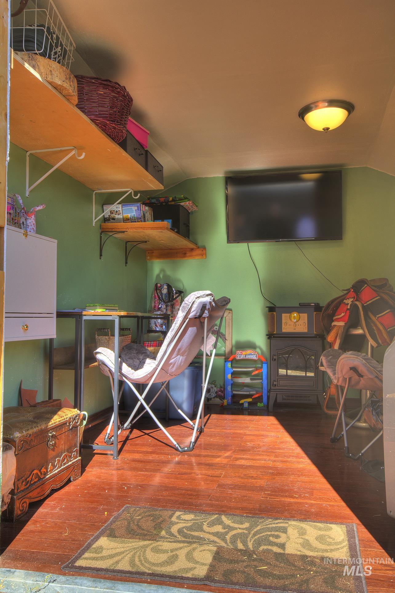 Bedroom with dark wood finished floors and lofted ceiling