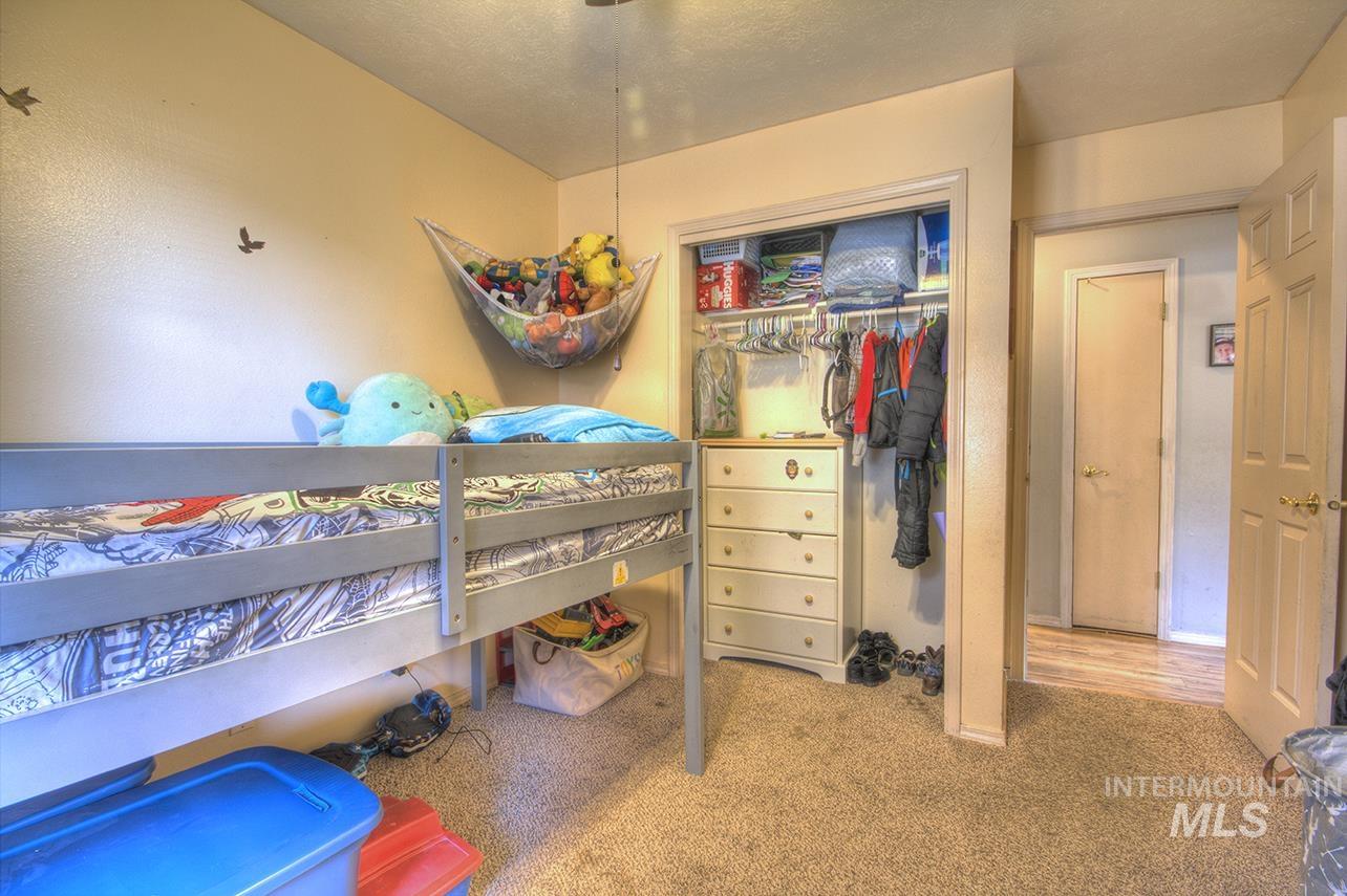 Bedroom featuring light carpet and a closet