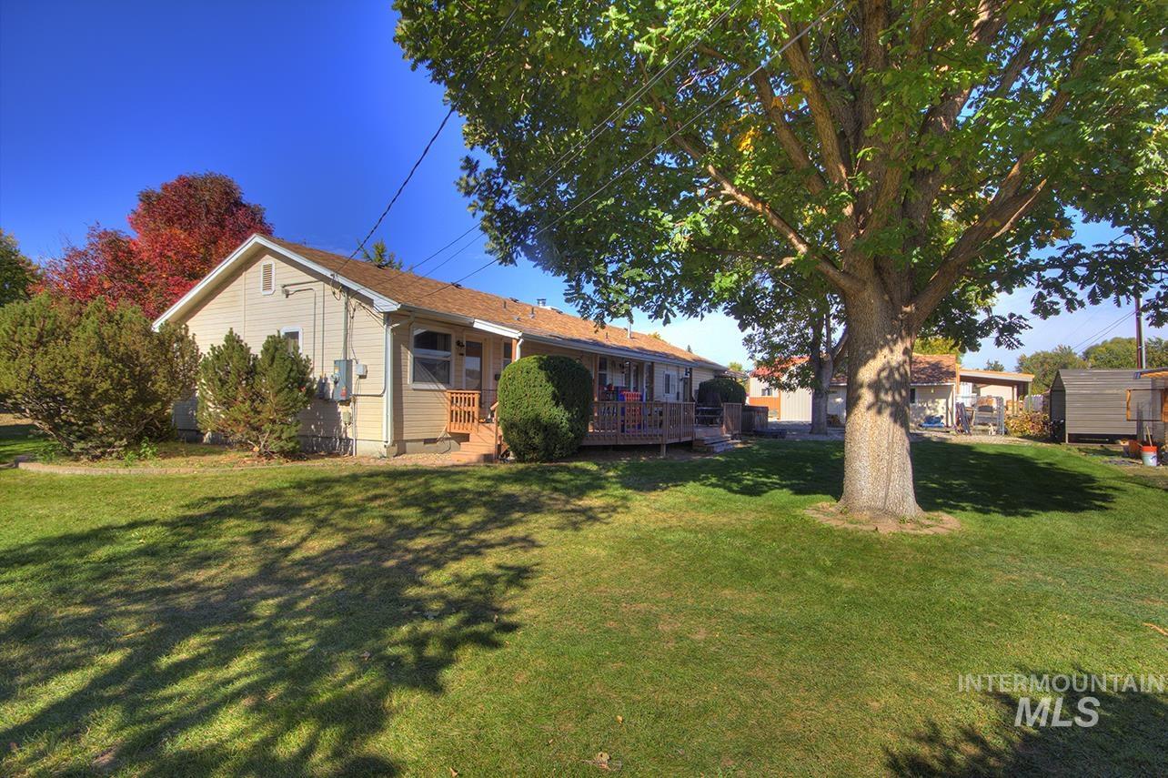 View of front facade with a front lawn and a deck