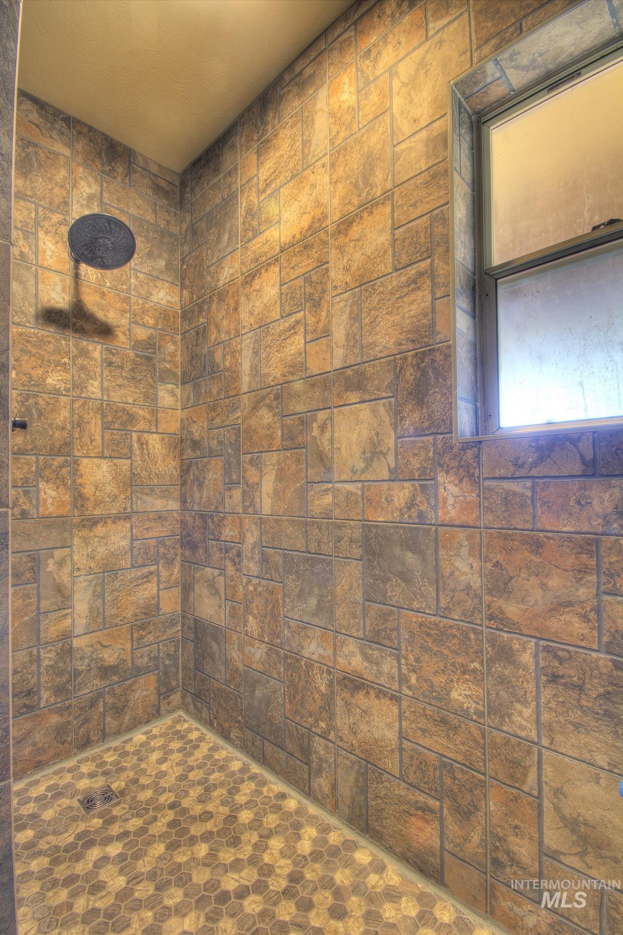 Bathroom featuring tiled shower