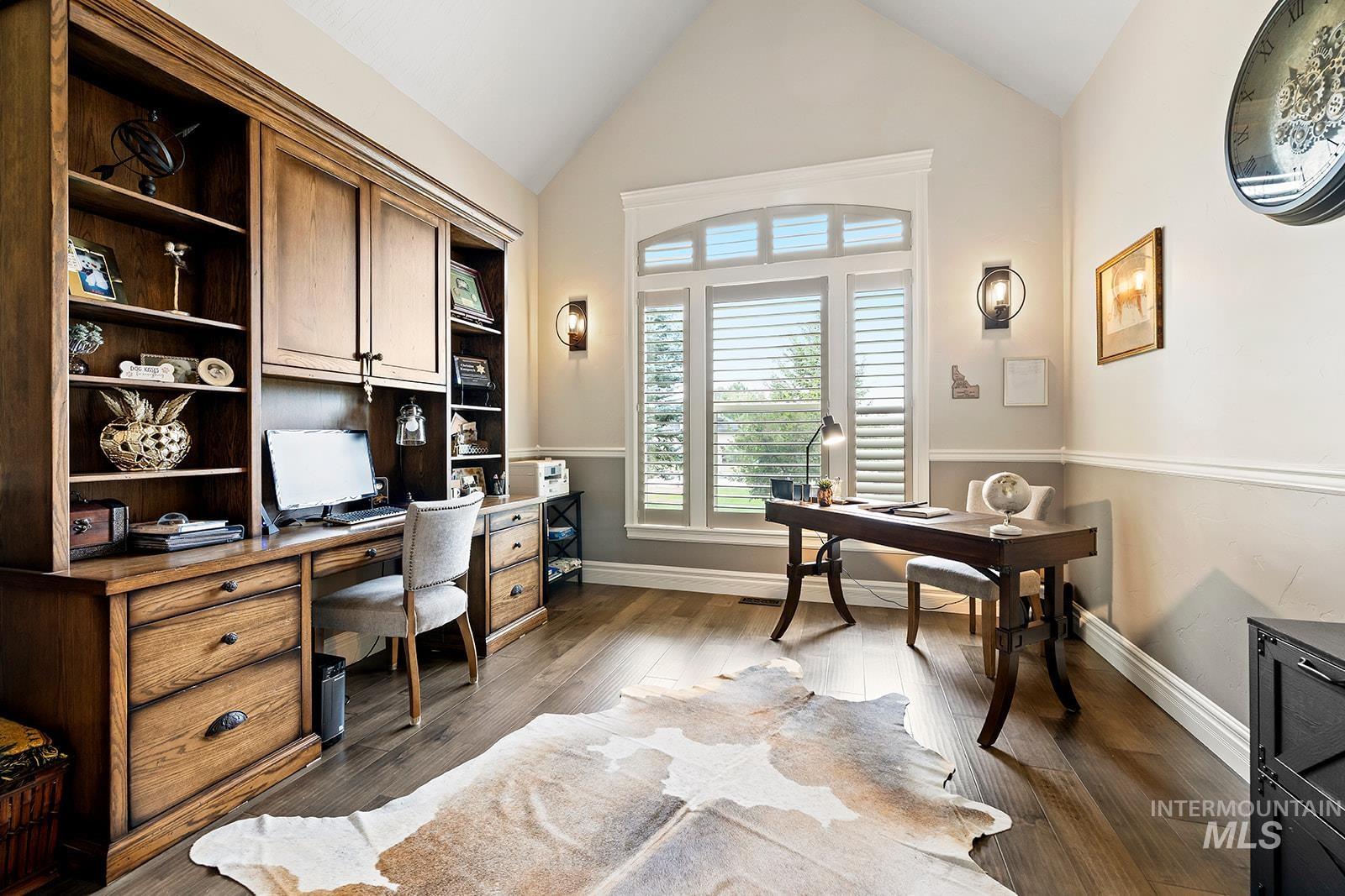 Office area featuring wood finished floors and high vaulted ceiling
