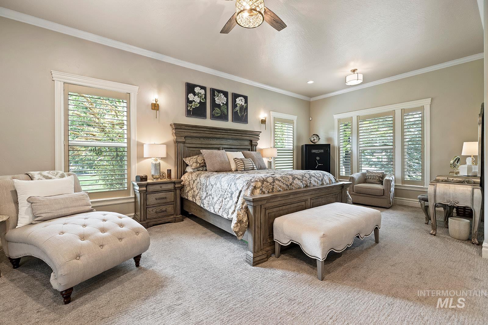 Bedroom featuring crown molding, carpet floors, and ceiling fan