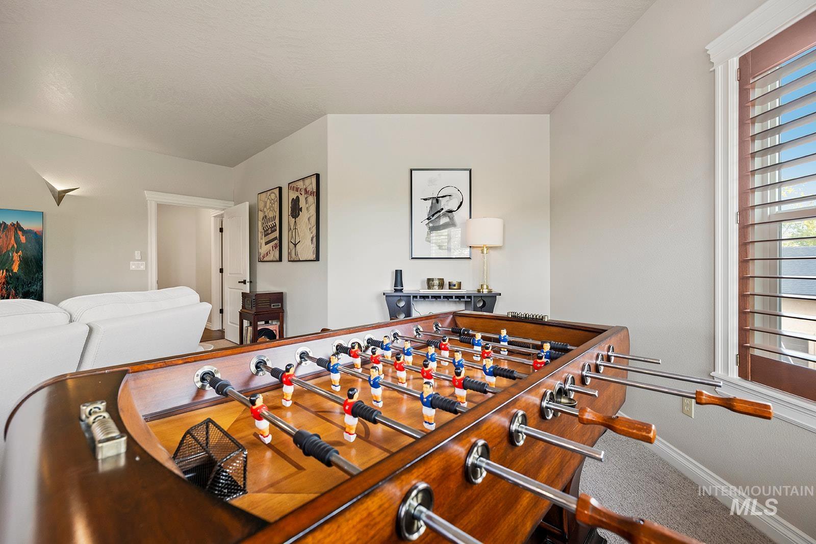 Rec room with carpet and baseboards