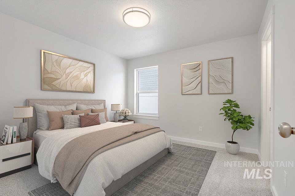Bedroom featuring carpet floors and baseboards