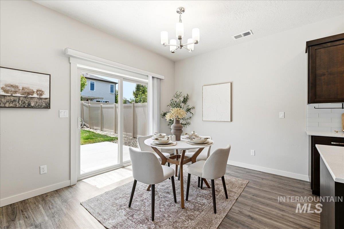 Sliding glass door opening to a private patio and fenced yard, offering abundant natural light