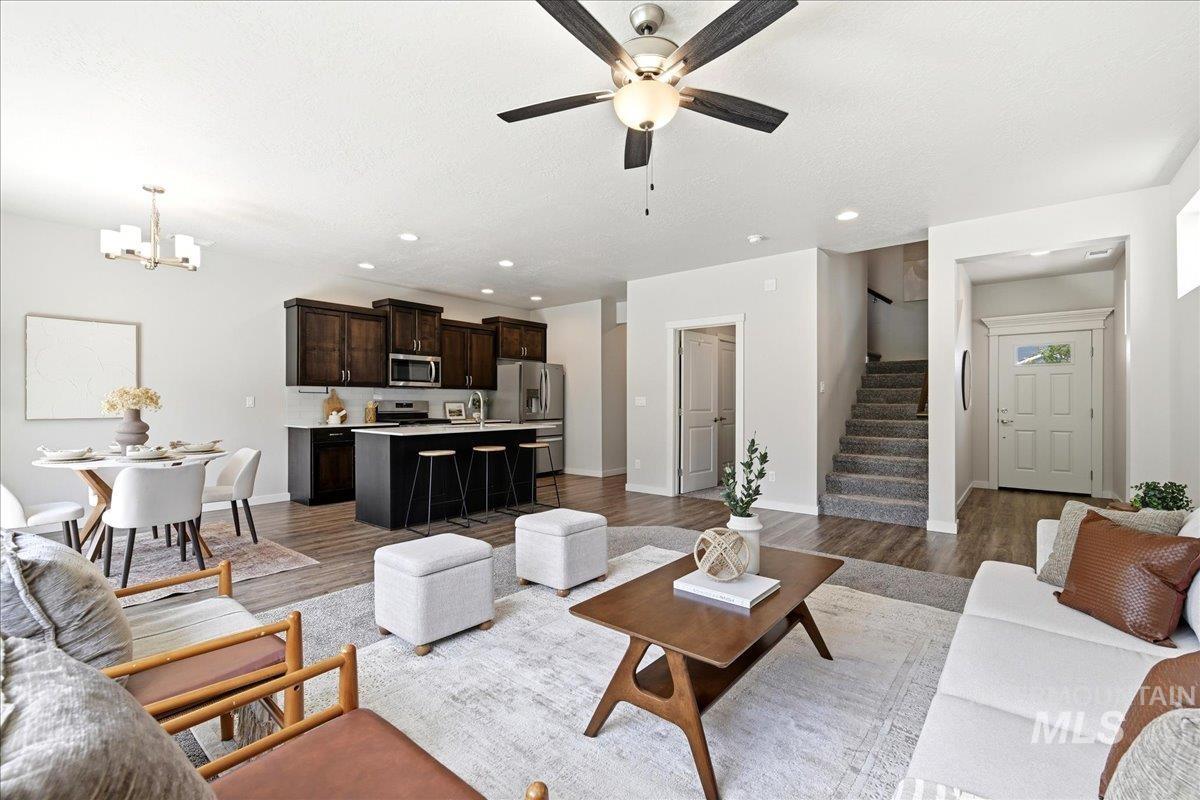 Open-concept living space featuring wood-finish flooring, recessed lighting, and a ceiling fan