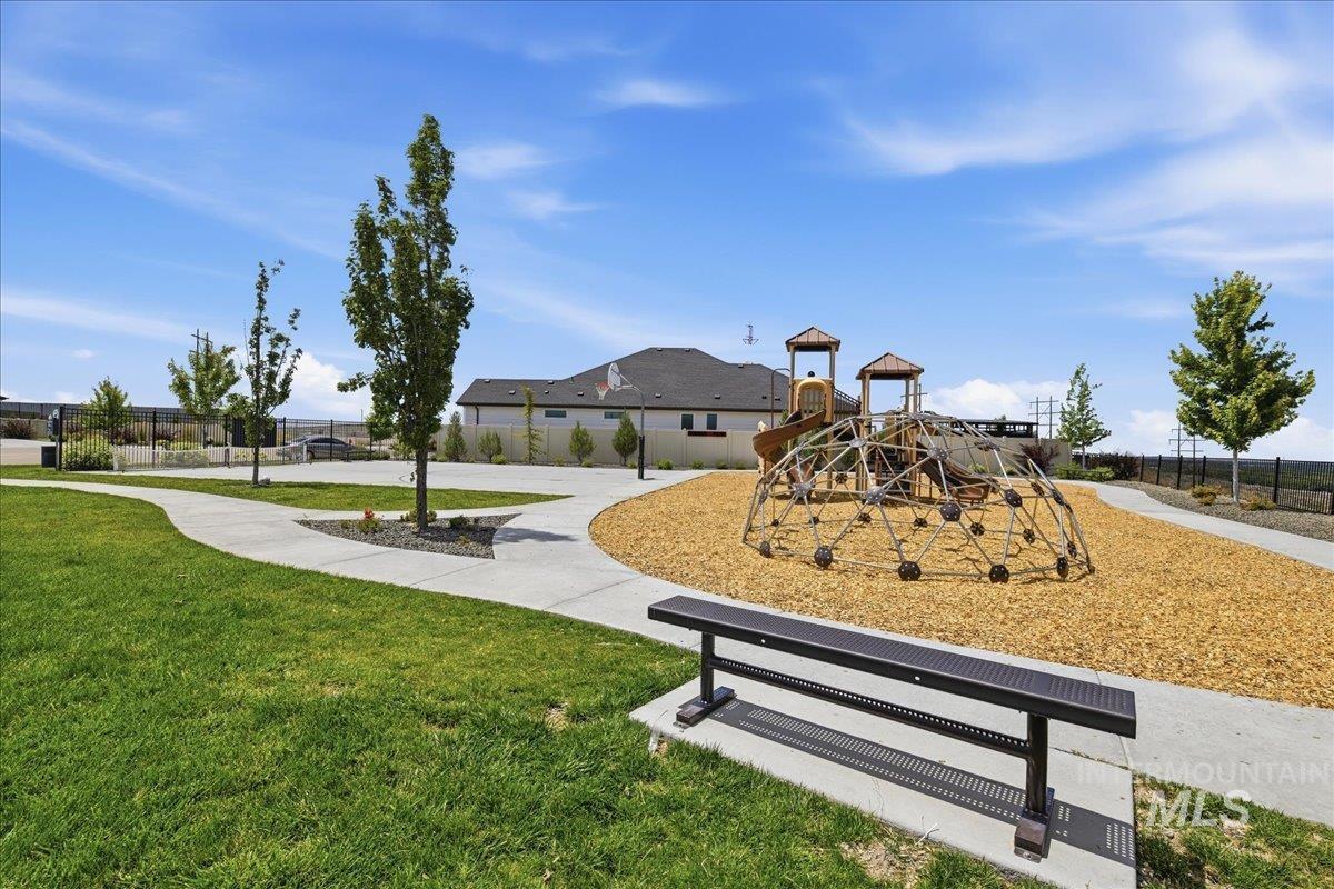Community playground featuring a climbing dome, slide structure, and wood chip surfacing