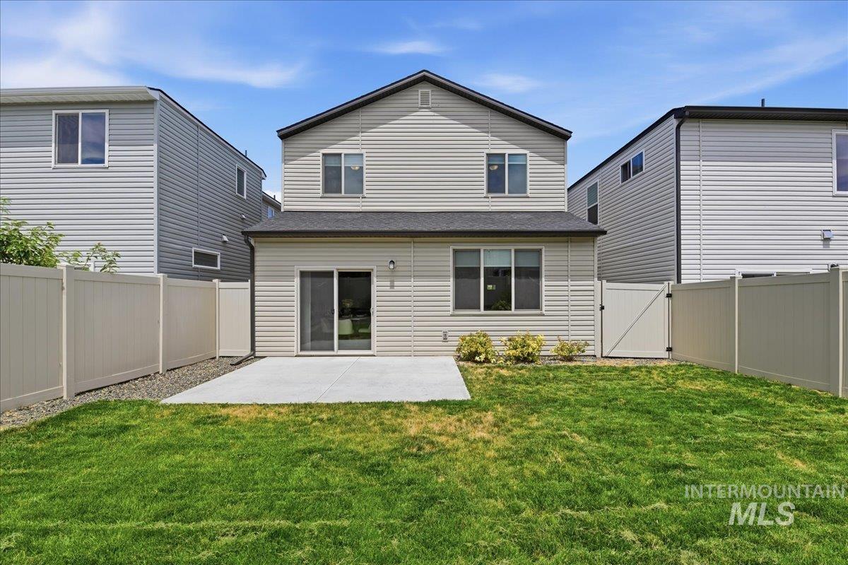 Fenced backyard featuring a concrete patio and a sliding glass door entry to the home