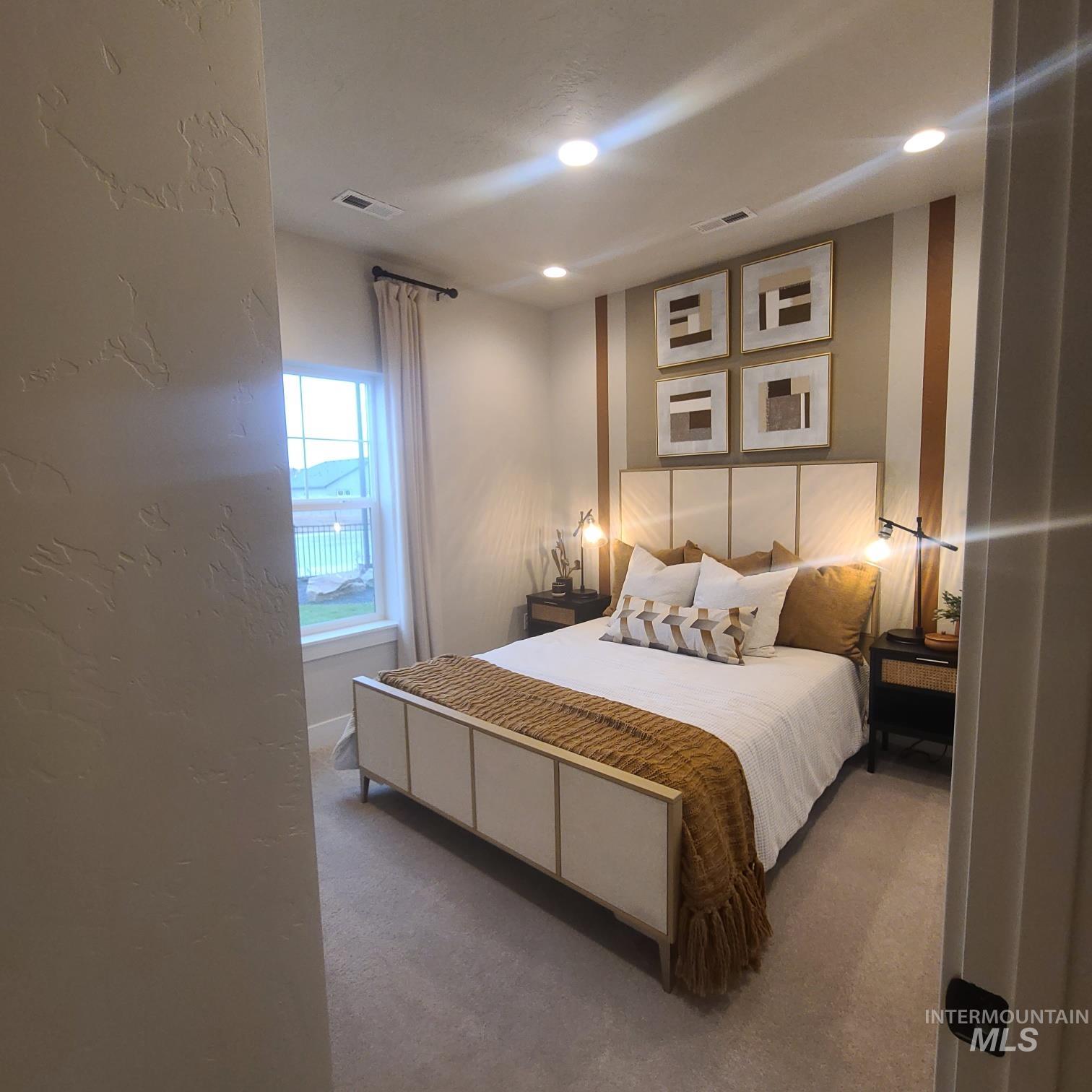 Carpeted bedroom with a textured wall
