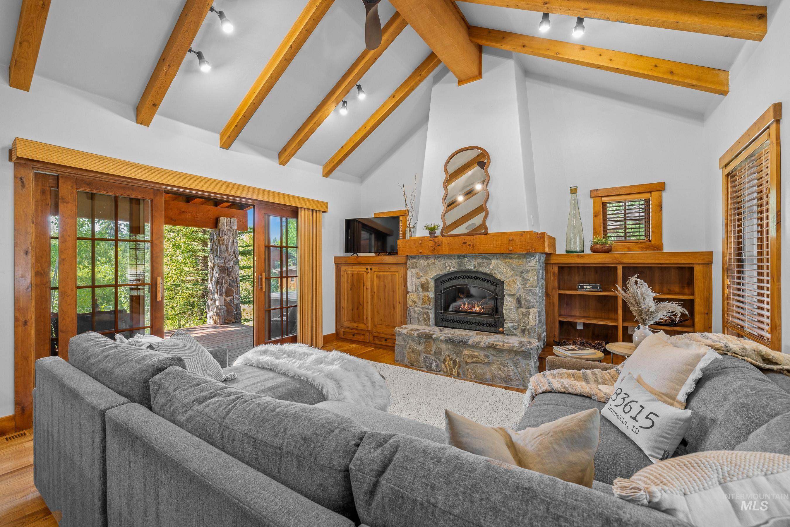 Living area featuring high vaulted ceiling and a fireplace