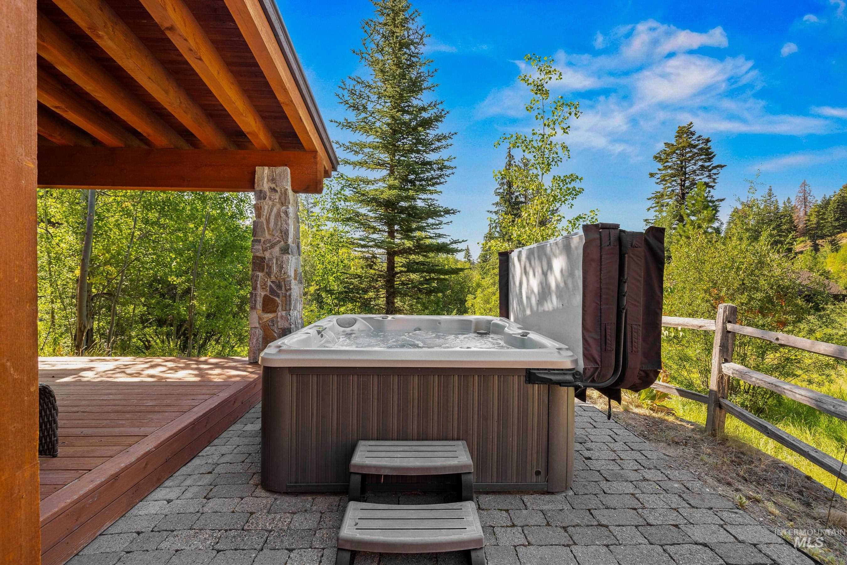 View of hot tub and deck