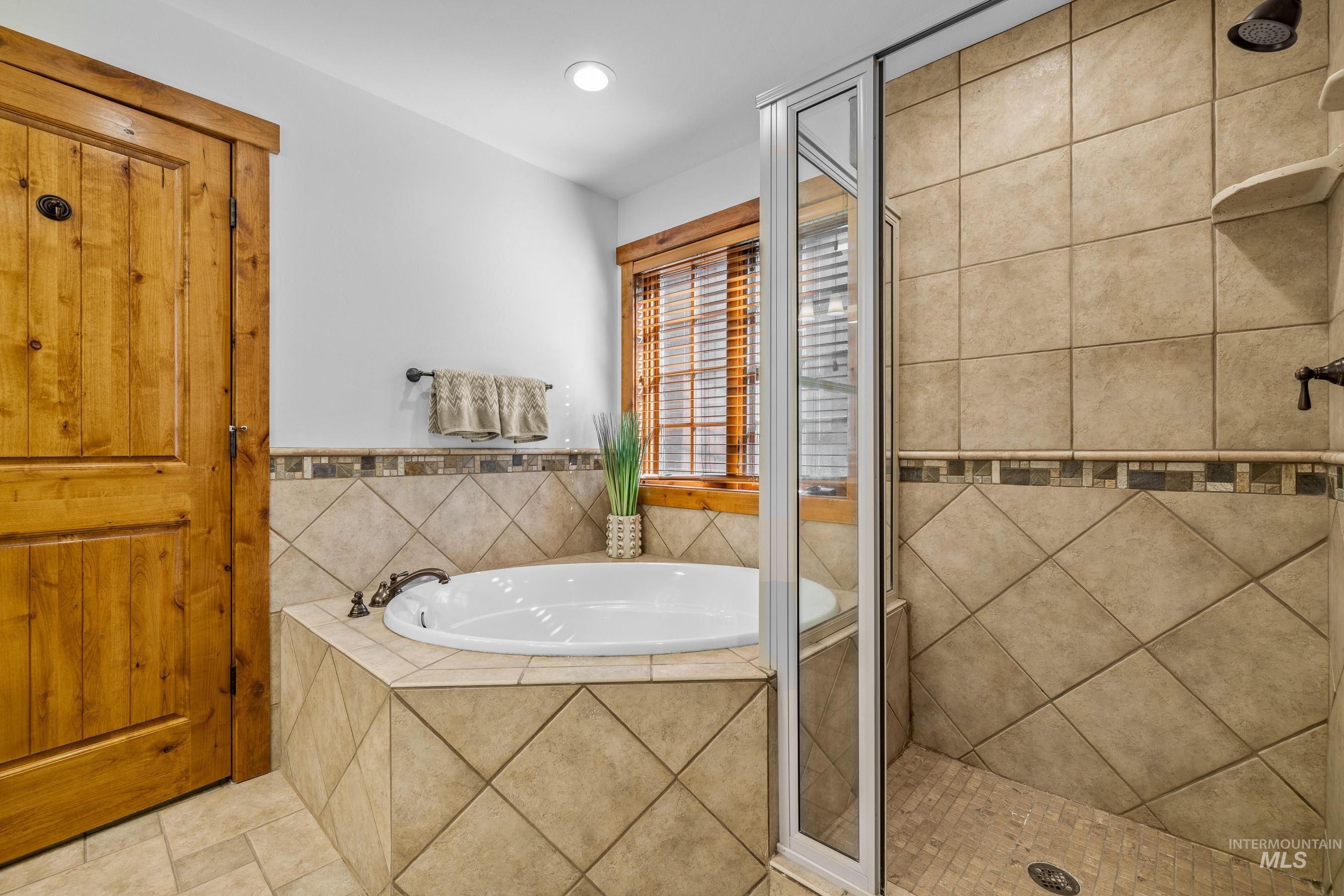 Bathroom featuring a stall shower and tub