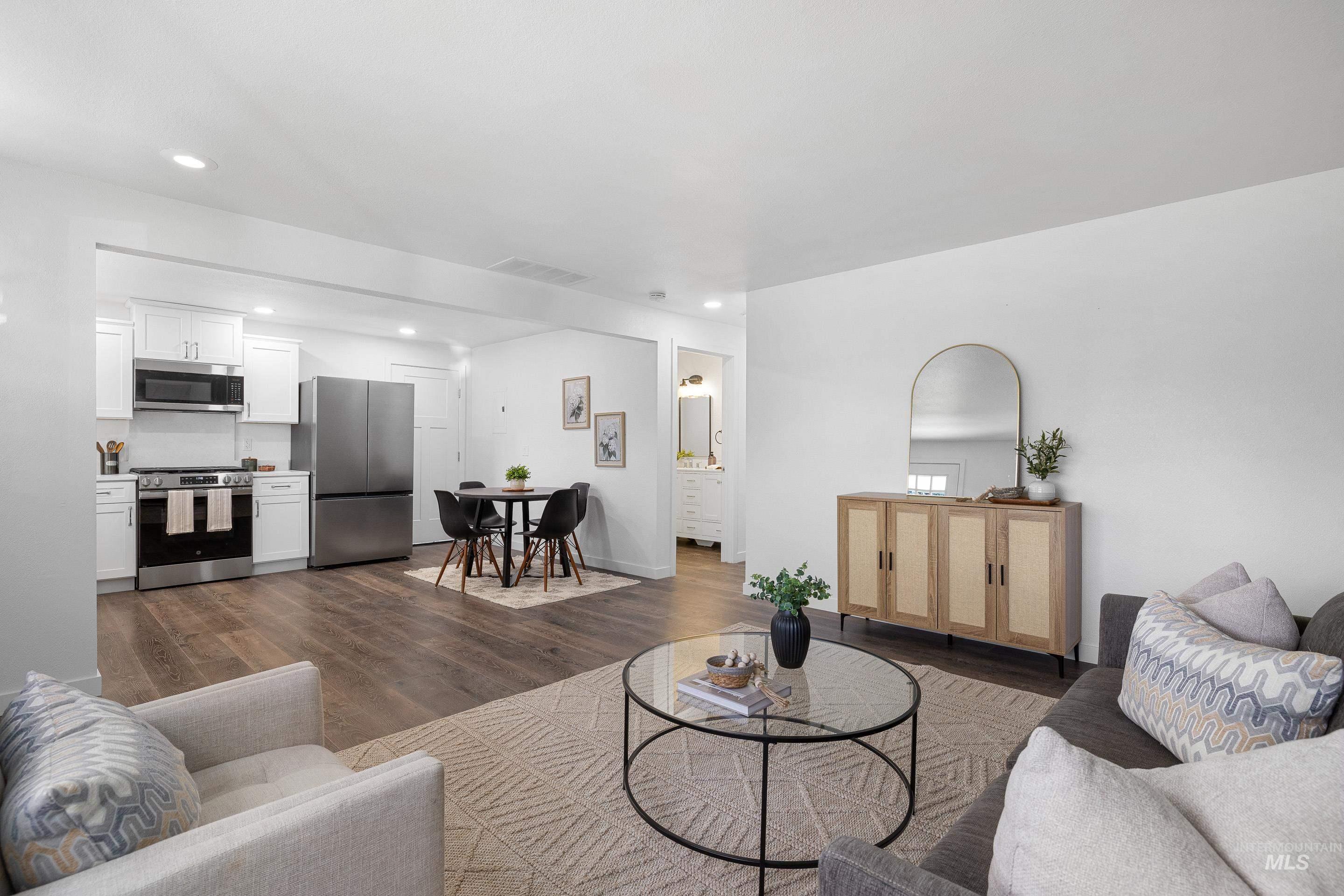 Living room featuring dark wood-type flooring and recessed lighting