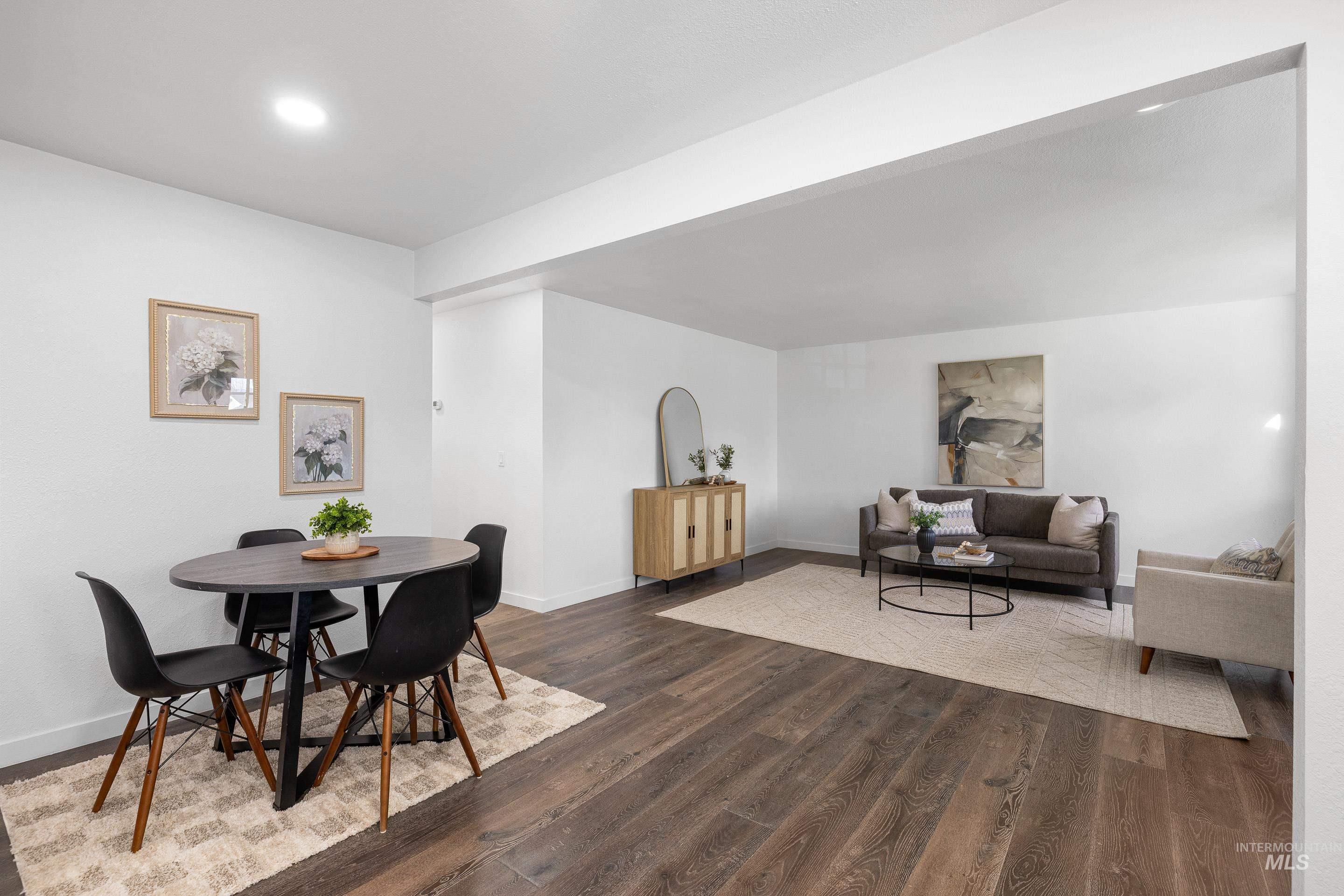 Dining space featuring dark wood-style floors and baseboards