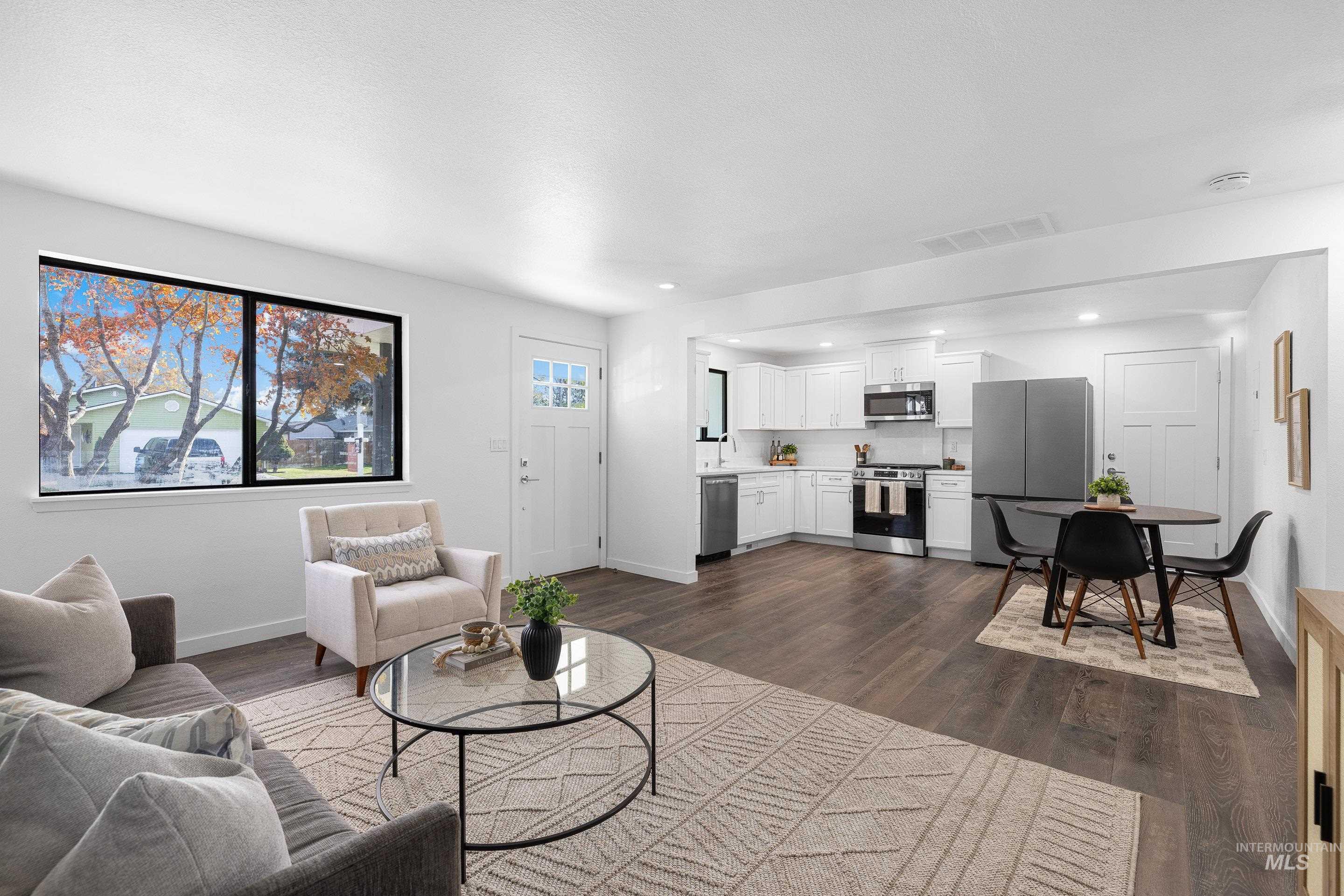 Living room with dark wood-style flooring and recessed lighting