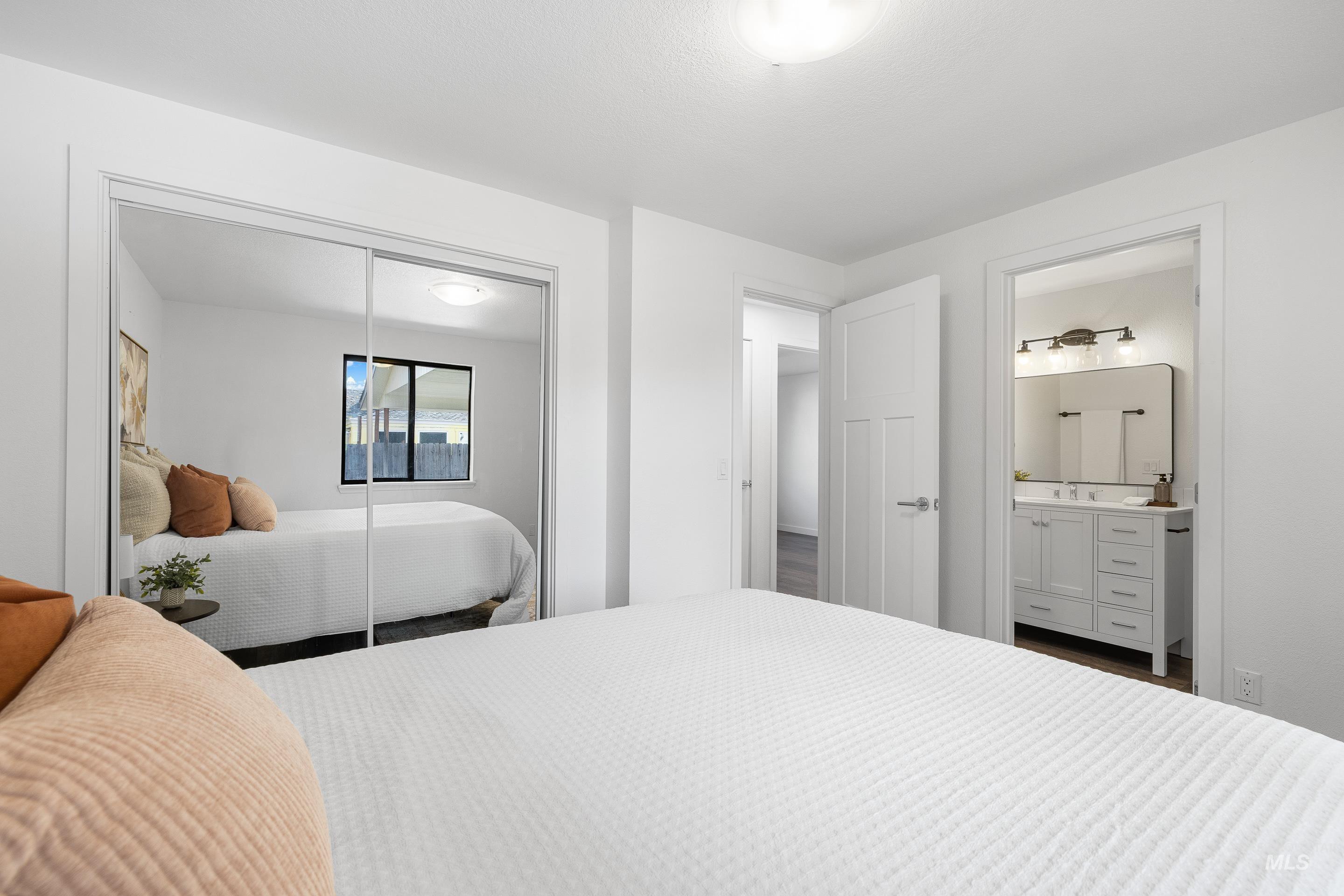 Bedroom with a closet and ensuite bath