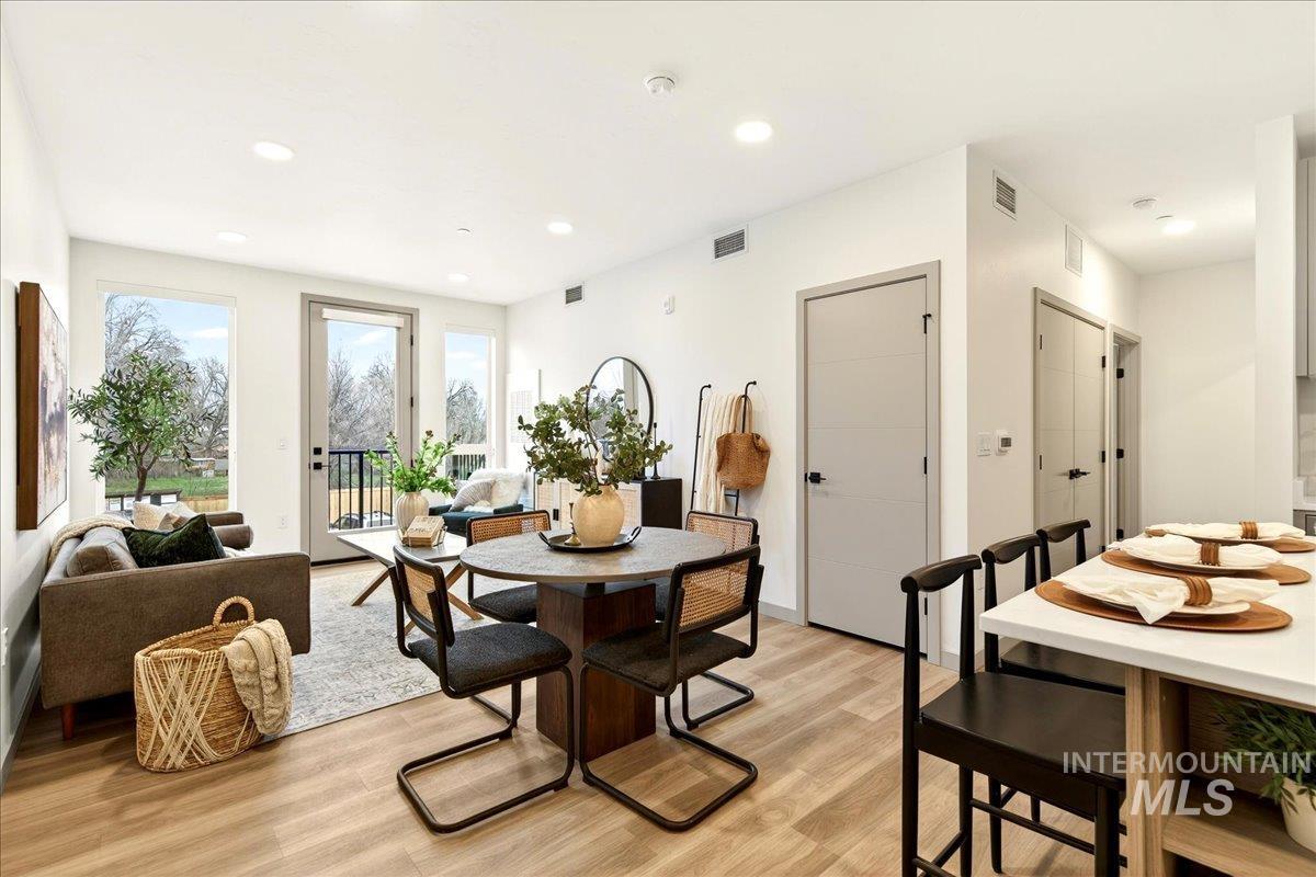 Dining room featuring light wood-style flooring and recessed lighting