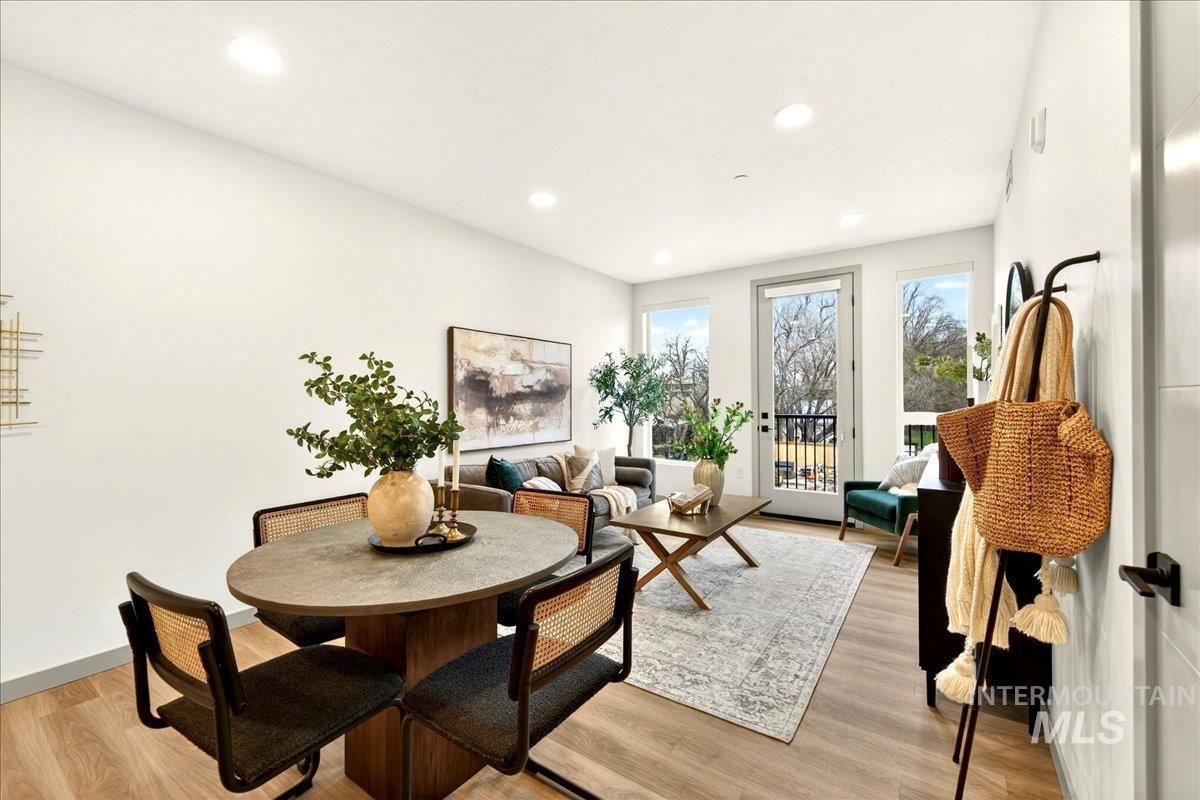 Dining area with light wood-style flooring and recessed lighting
