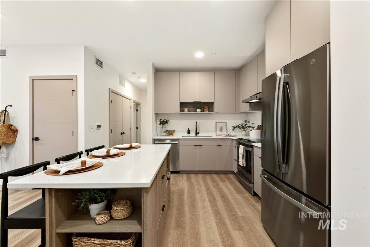 Kitchen featuring open shelves, stainless steel appliances, a kitchen island, modern cabinets, and recessed lighting