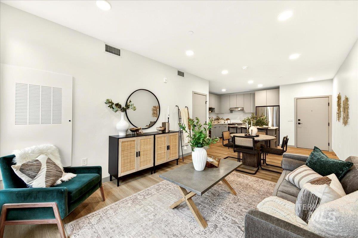 Living area with light wood-style floors and recessed lighting