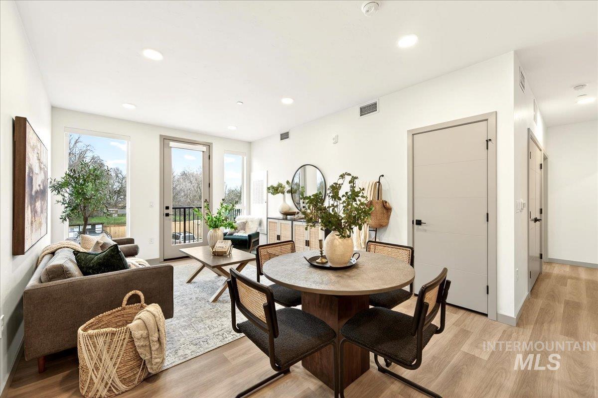 Dining space with light wood-style flooring and recessed lighting
