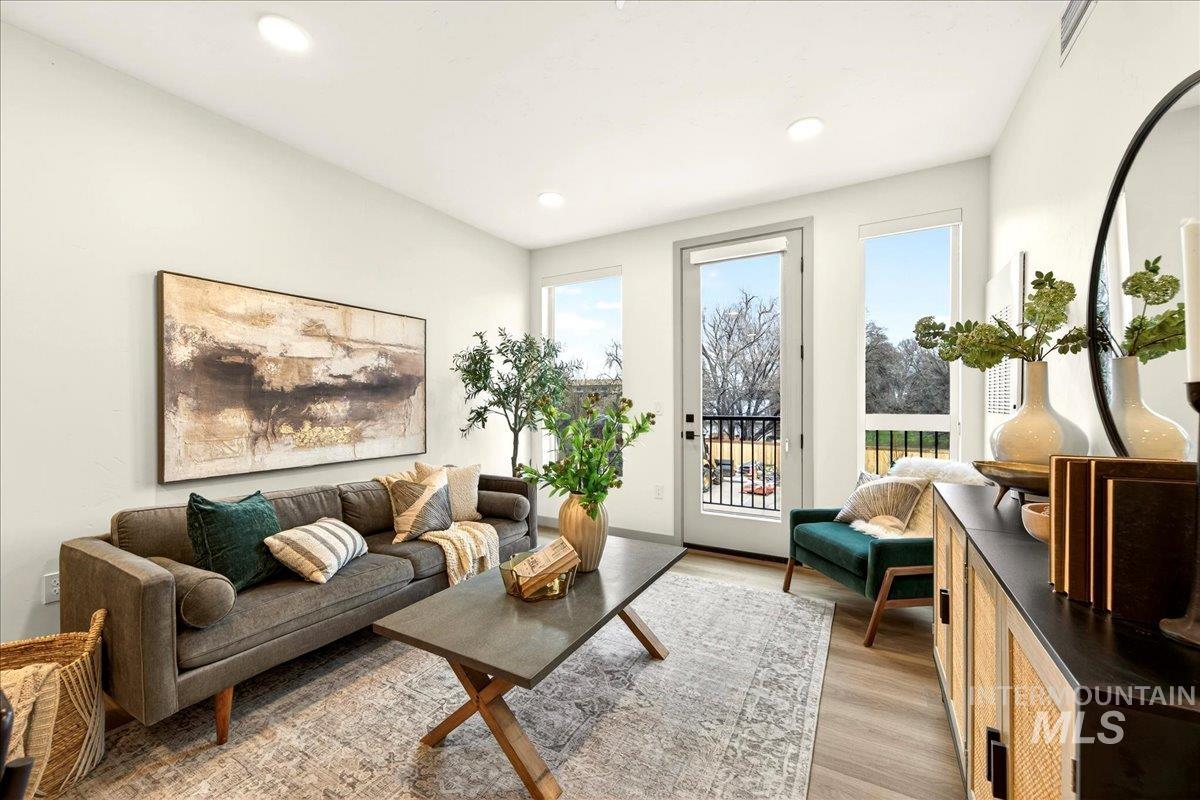 Living area featuring light wood-type flooring and recessed lighting