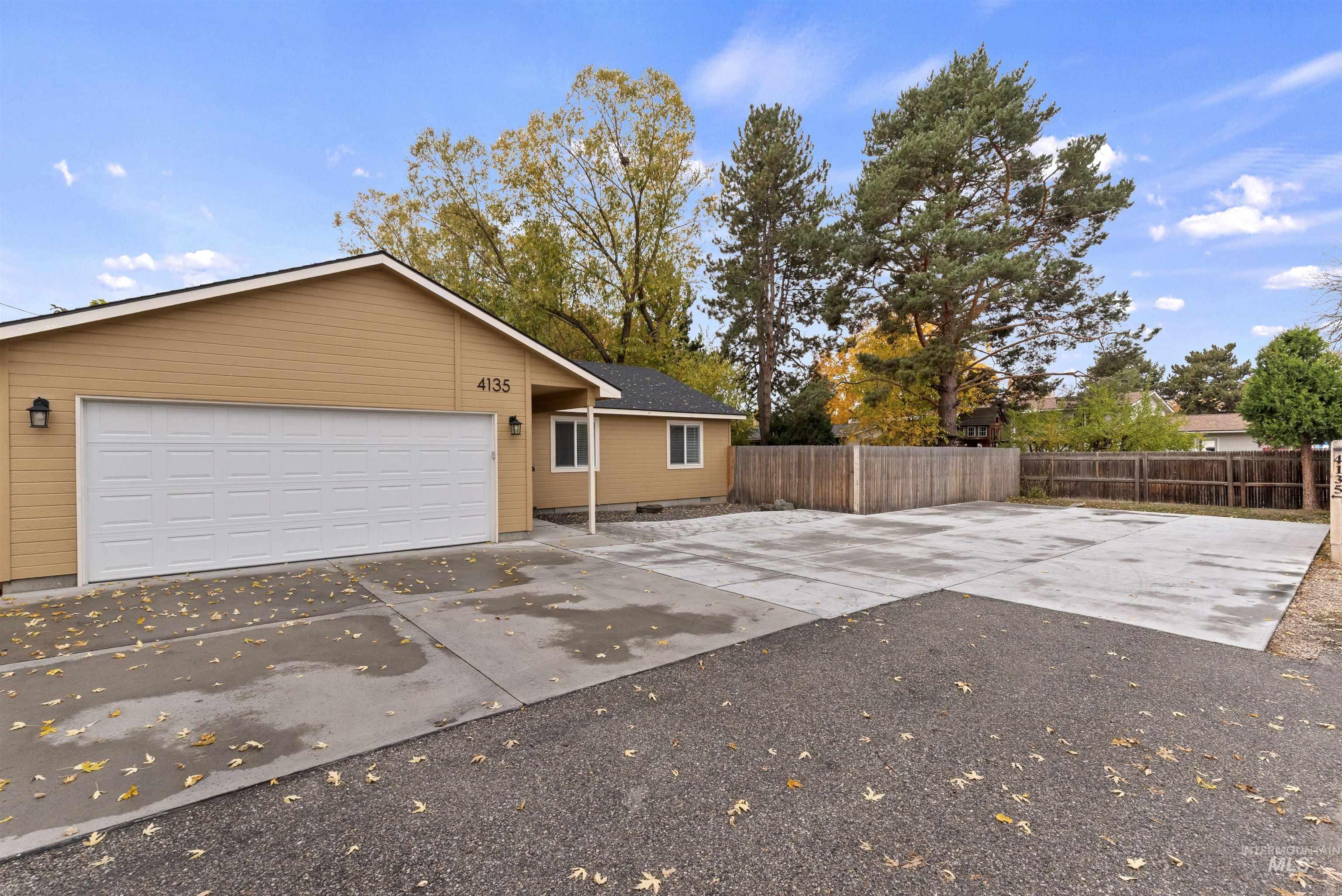 View of front of house with concrete driveway and a garage
