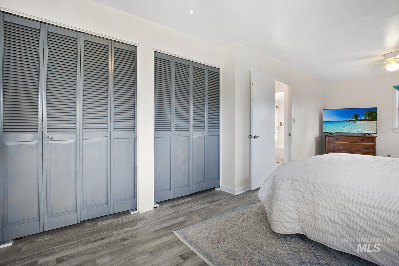 Bedroom featuring multiple closets and wood finished floors