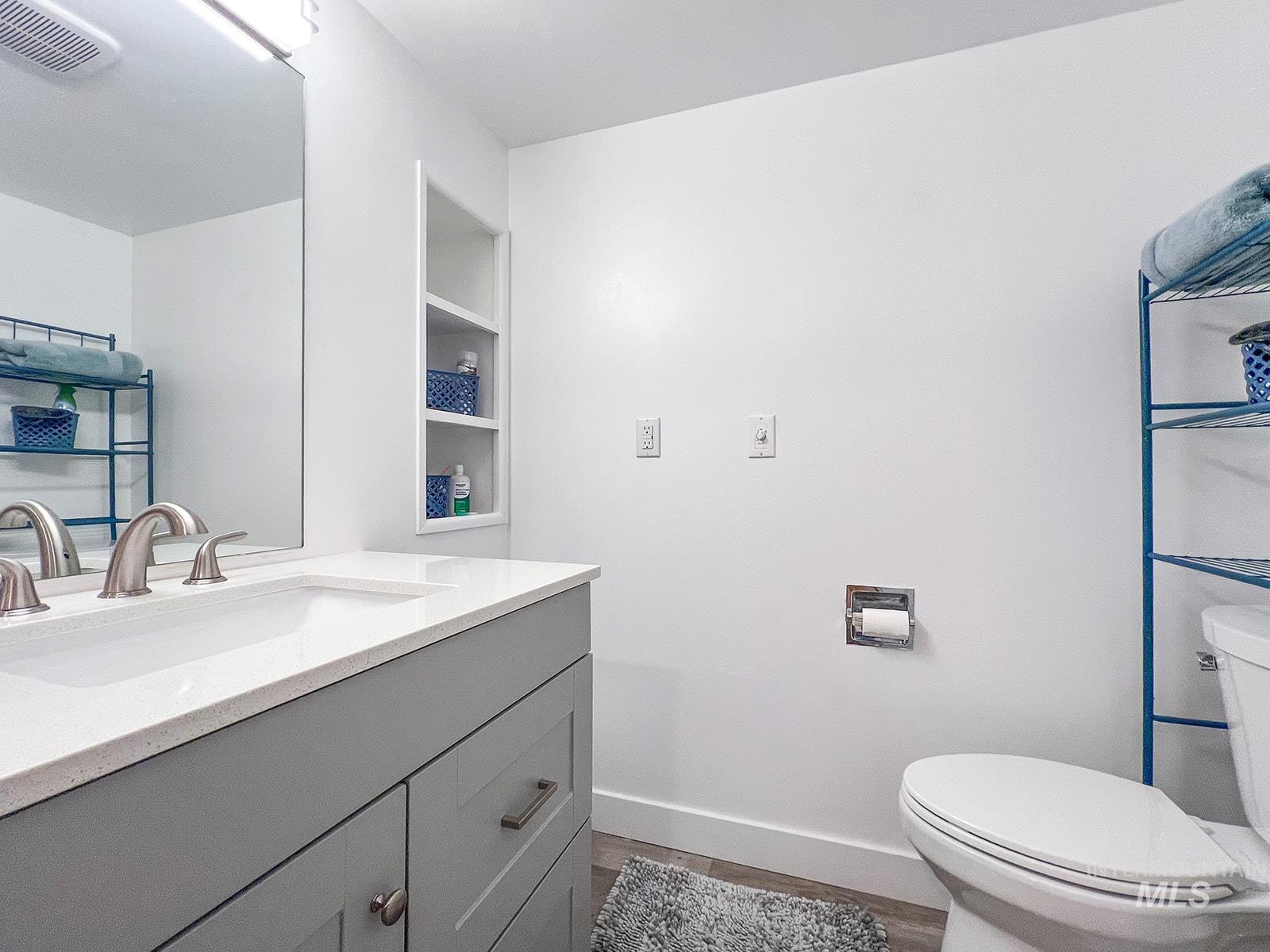 Bathroom with vanity and dark wood finished floors
