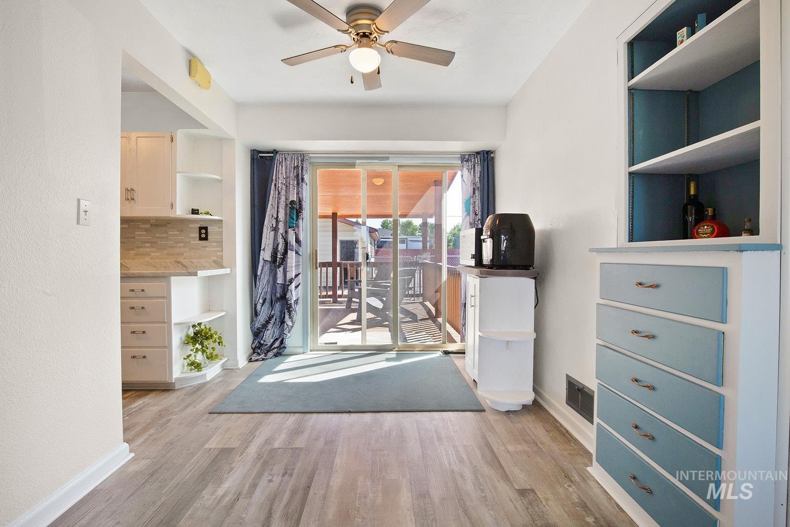 Dining area featuring light wood-type flooring and ceiling fan
