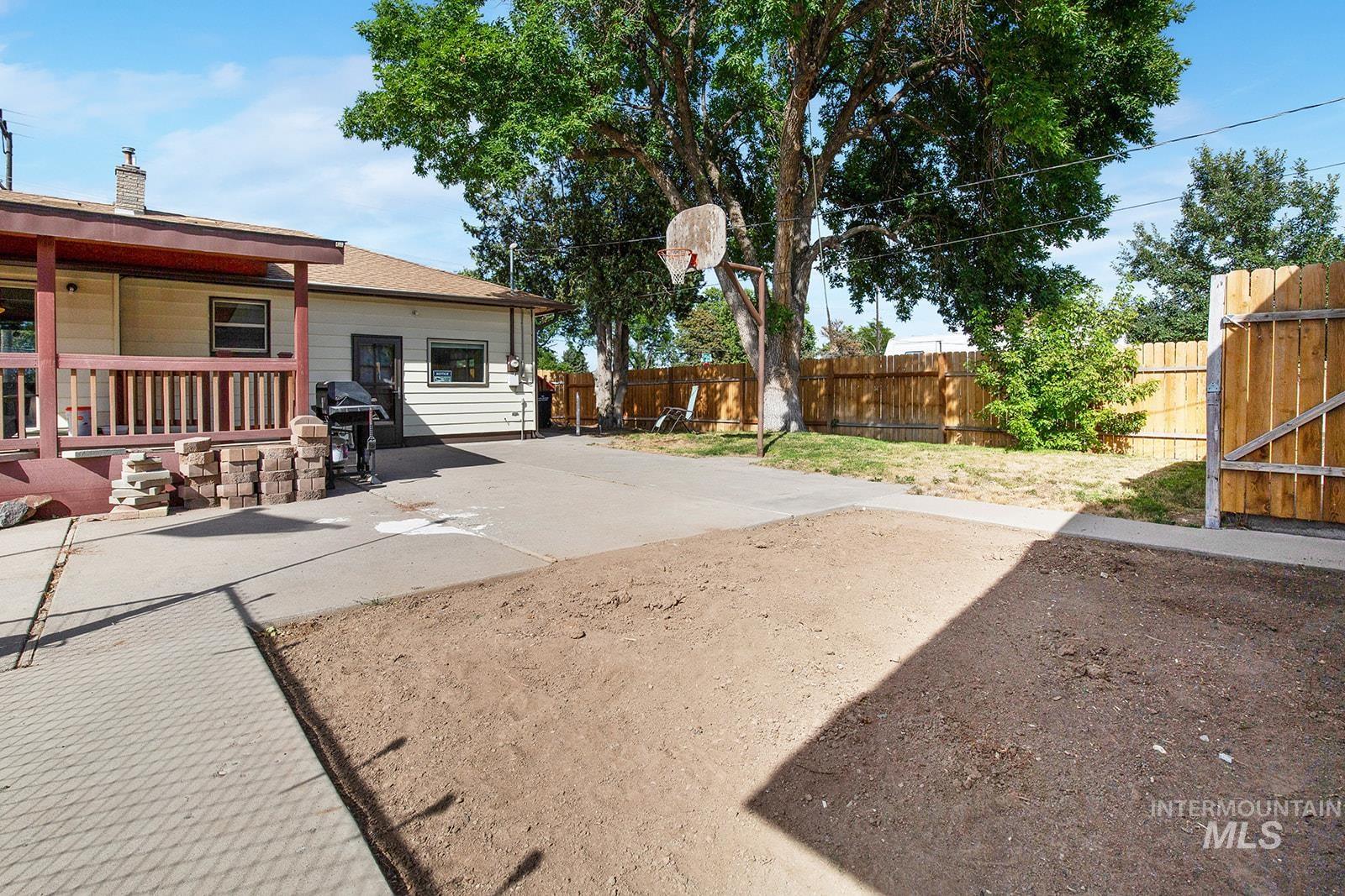 Fenced backyard featuring a patio