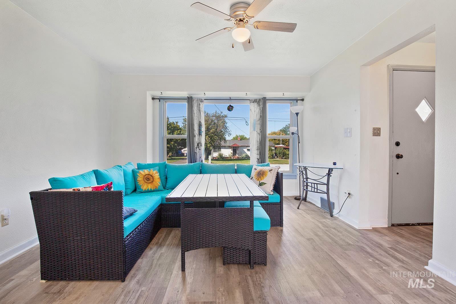 Living area featuring wood finished floors and a ceiling fan