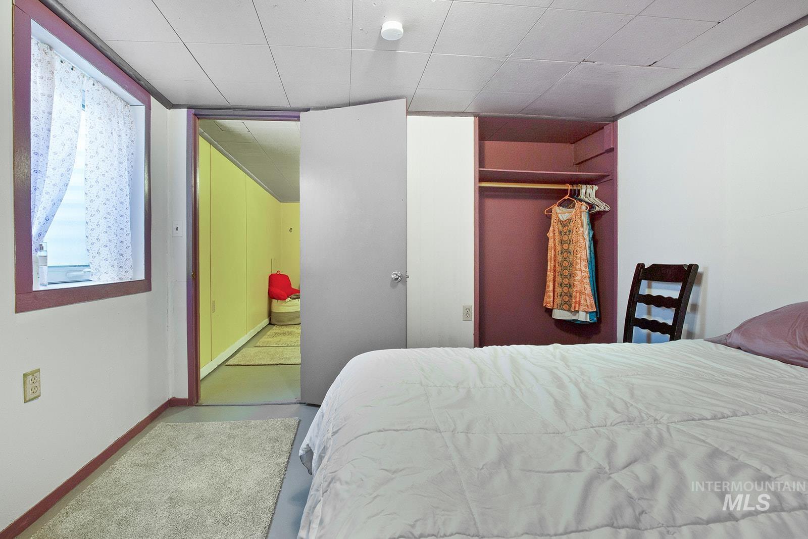 Bedroom featuring a closet and a paneled ceiling